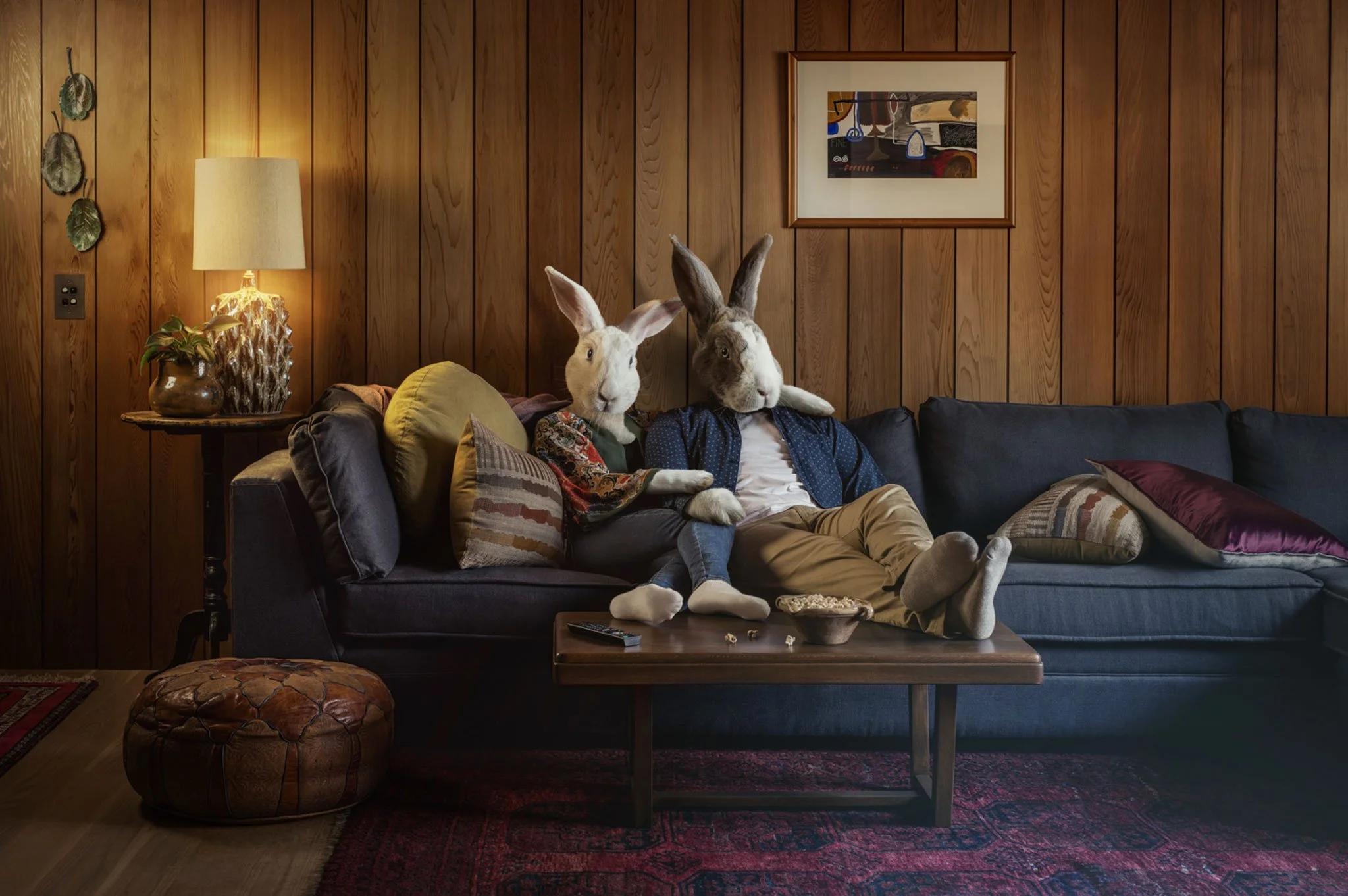 Surreal conceptual portrait of a rabbit-headed couple in a domestic interior, blending humour, narrative and portraiture. Shot for Cilatil
