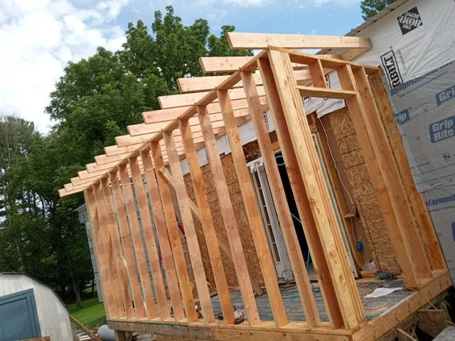 Oranssi technician working on a roof project
