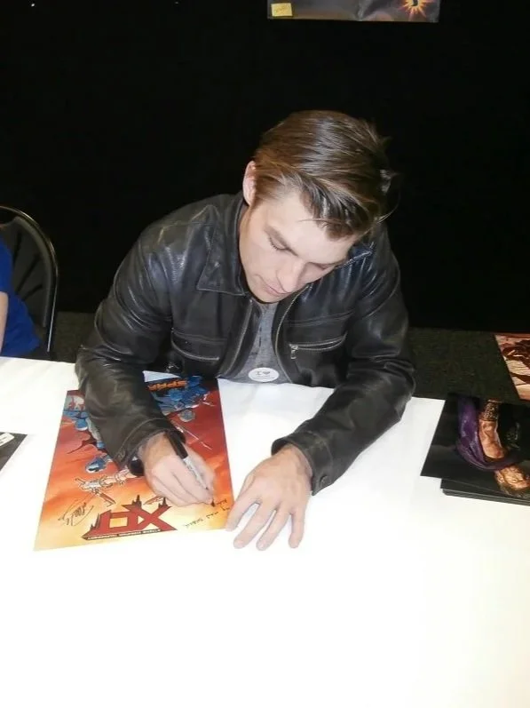 Liam McIntyre (Spartacus) signing some XCT posters at Supanova