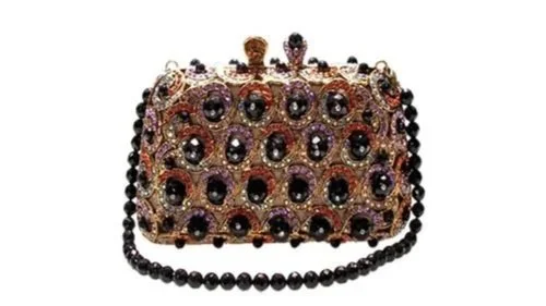 Luxurious clutch purse with black gemstones and intricate gold details.