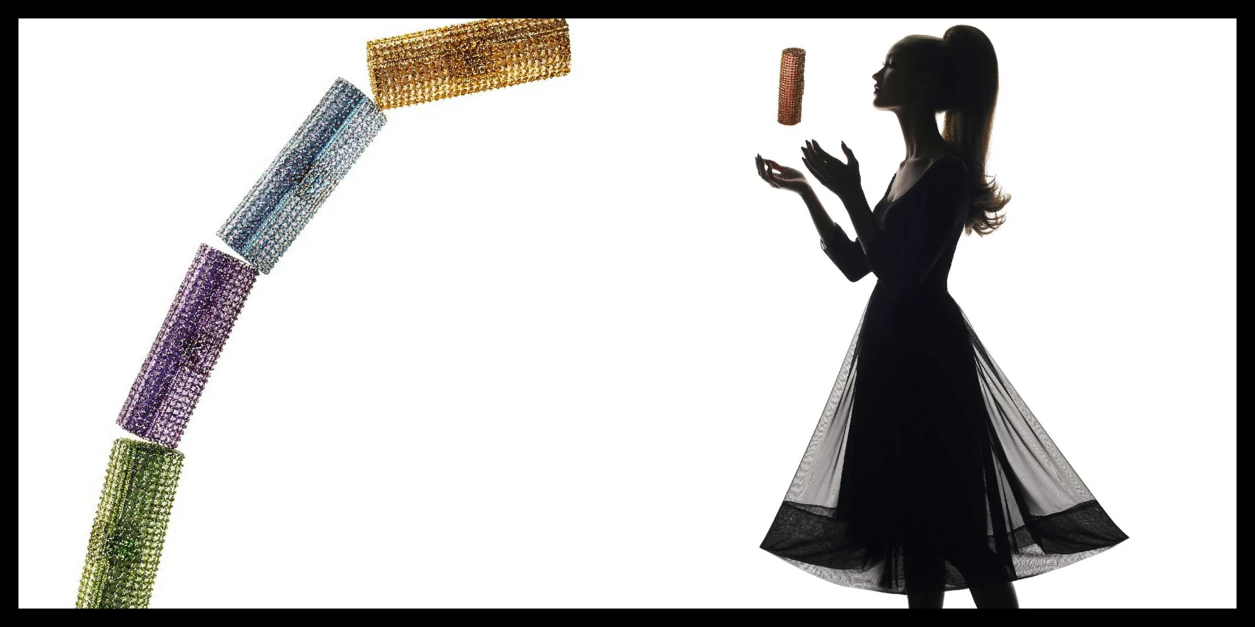 Silhouette of a woman in a flowing black dress juggling several glittering, cylindrical objects.