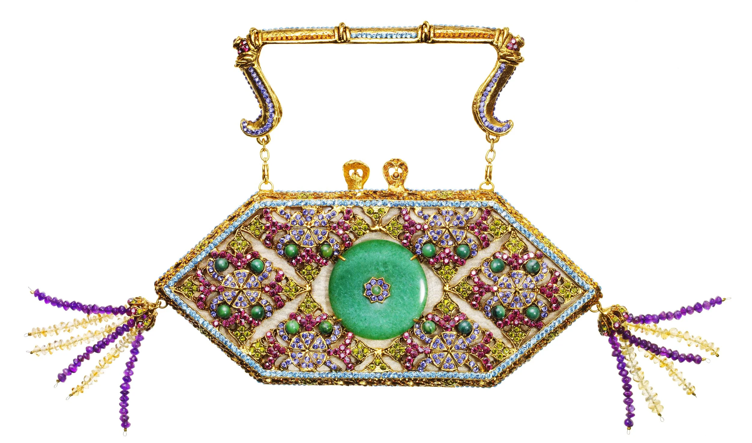 Intricate jewelry piece decorated with colorful gemstones, featuring green, pink, purple, and blue stones, with hanging beaded strands and a large central green gemstone, set against a white background.