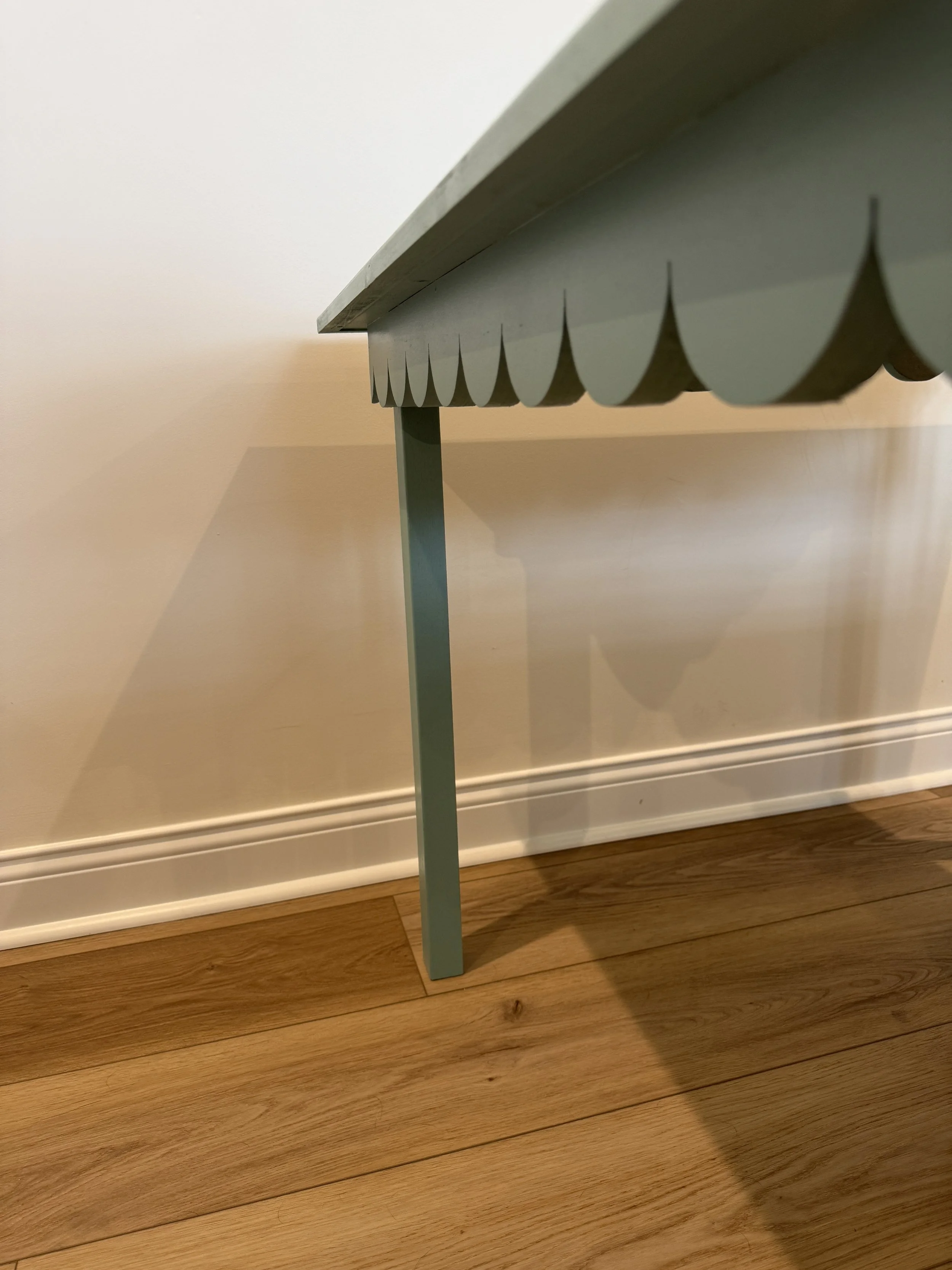Close-up detail of a handcrafted custom mahjong table featuring a scalloped edge design and elegant wood craft