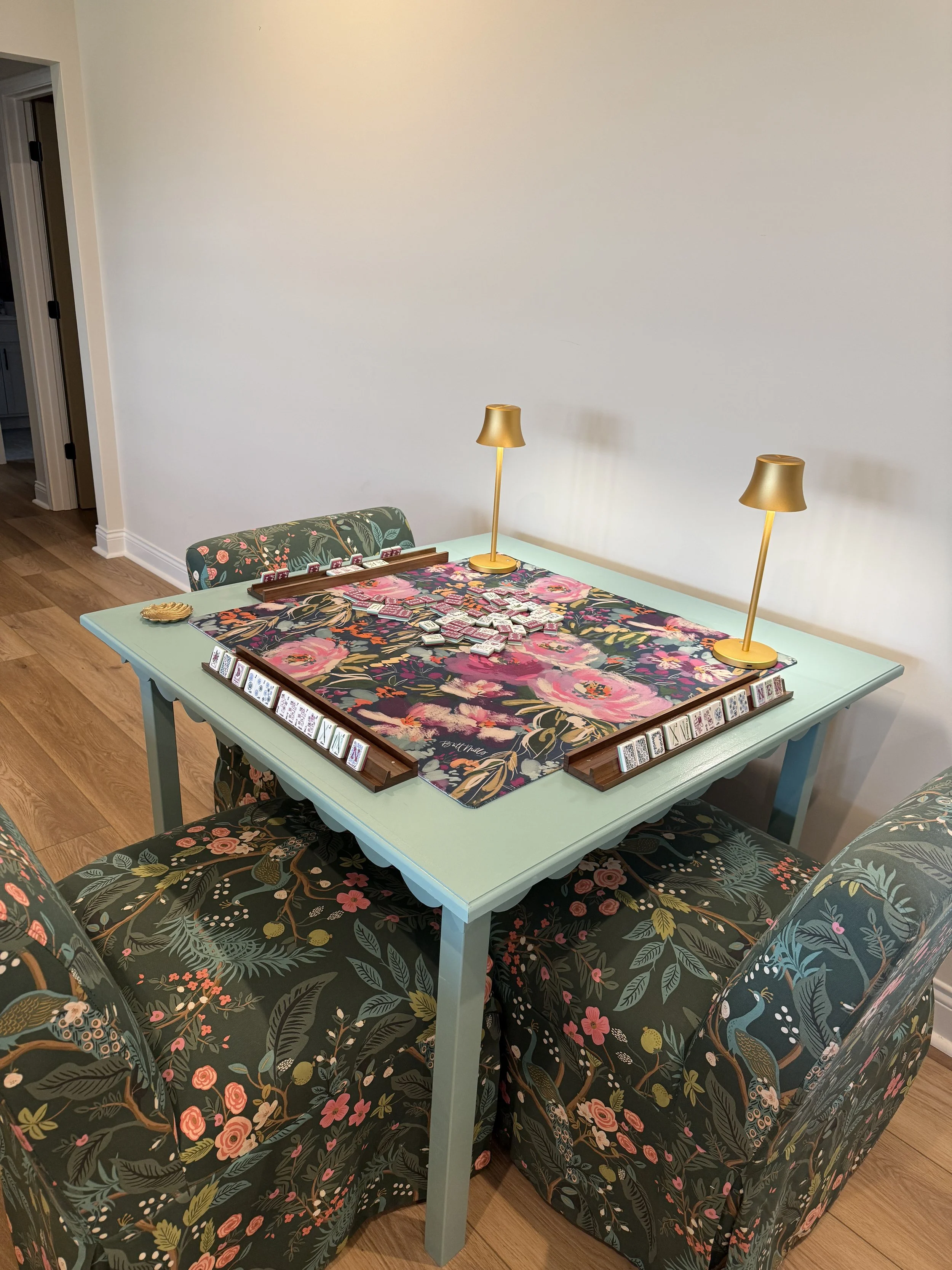 Handcrafted custom mahjong table by The Mahj Table Co with a floral table mat, elegant seating, and a stylish setup for mahjong nights