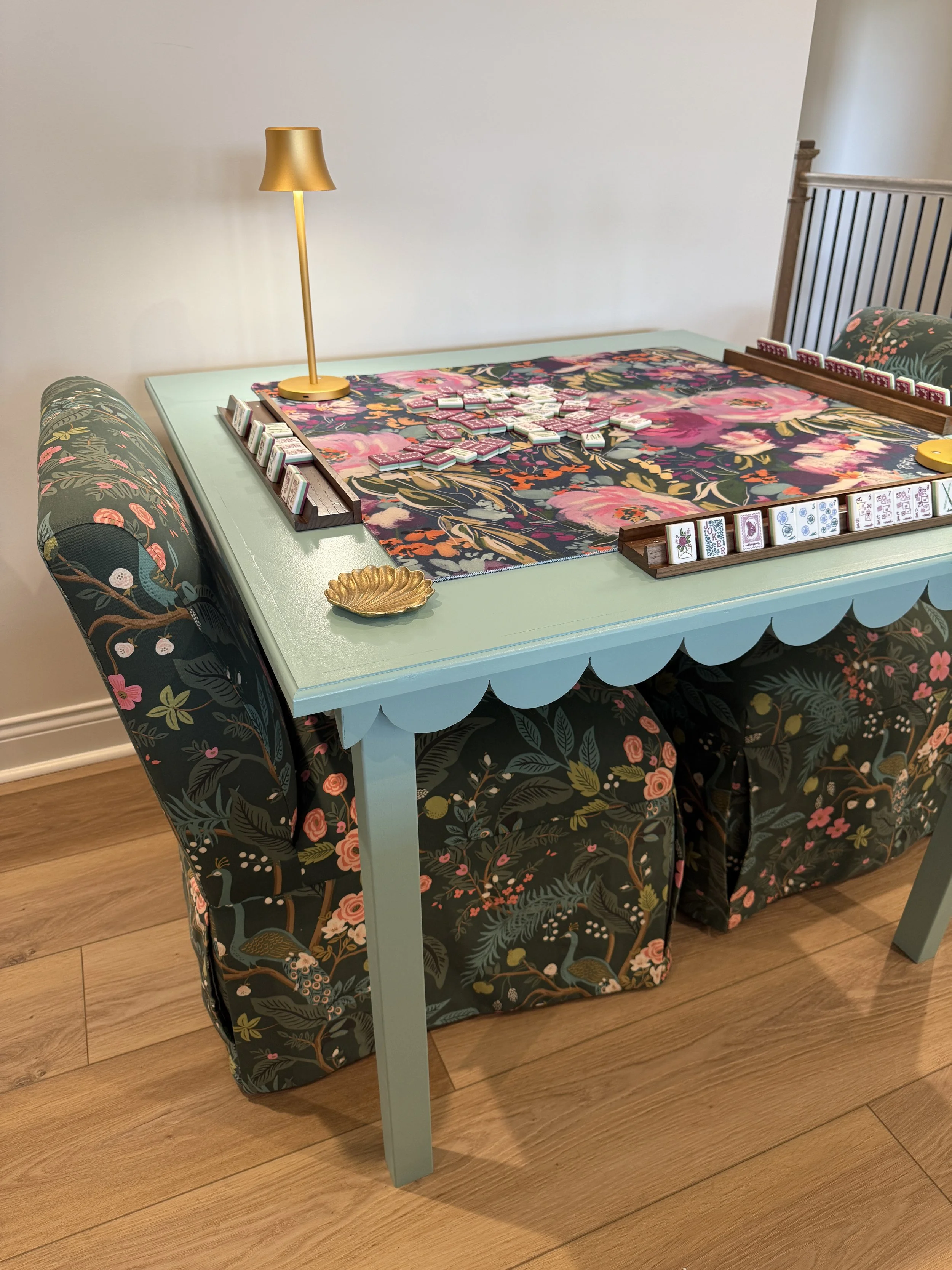 Custom green painted mahjong table by The Mahj Table Co with mahjong tiles, designer table mat, and a beautiful game night setup