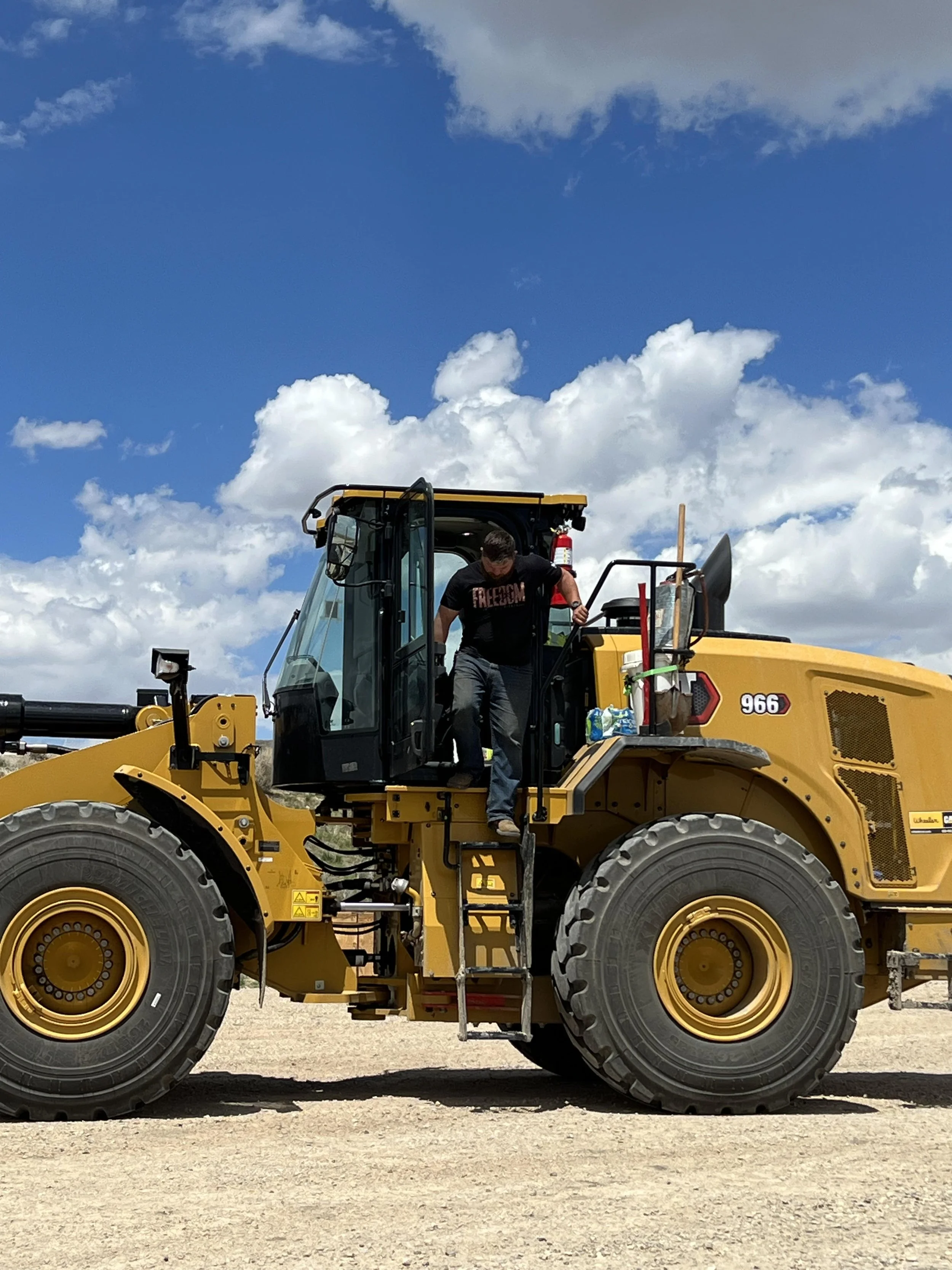 Heavy equipment operator with heavy equipment used for property improvement work.