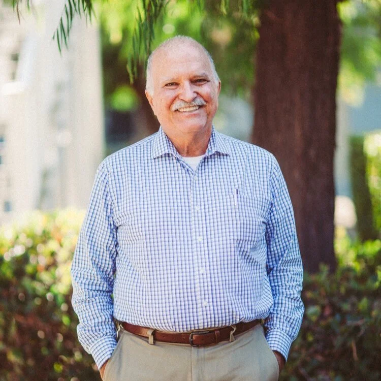 Cal Stevens, Session Advisor for Witness, smiling outdoors in a blue checked shirt