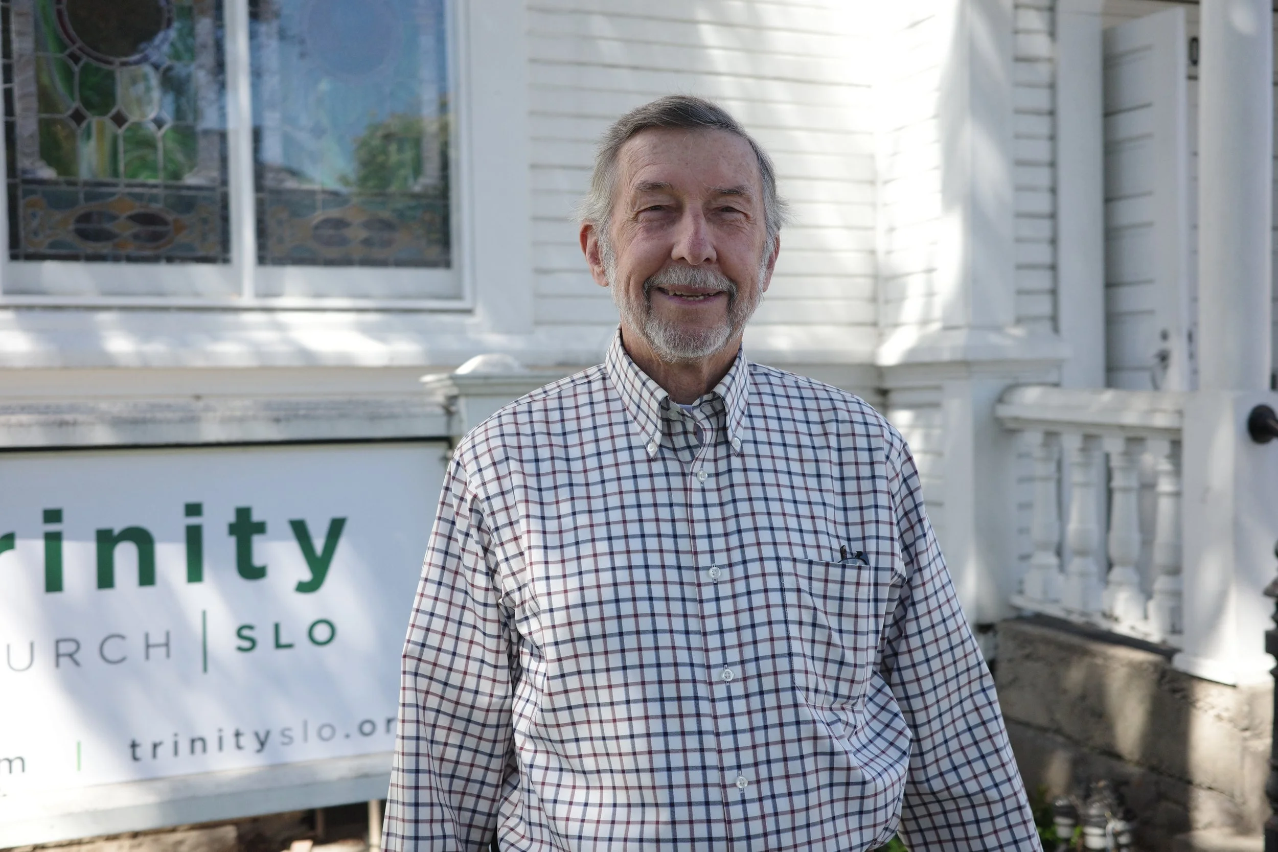 Jim Hawthorne, Mercy Team, smiling outdoors in a checked shirt