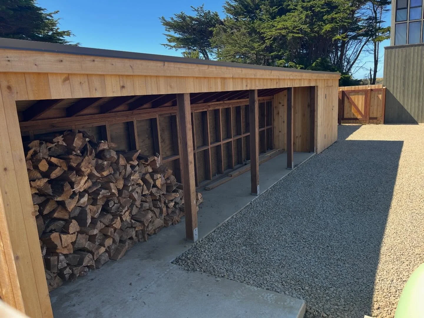 New courtyard: driveway, firewood storage and shed and fences
