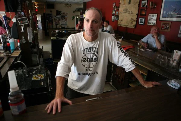 Gregg Sousa standing behind a bar counter at the Crows Nest