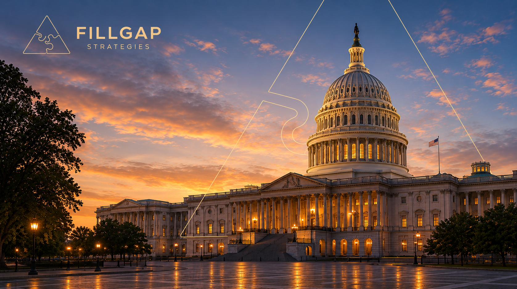 The United States Capitol building at sunset with an orange and blue sky, trees, and American flags.