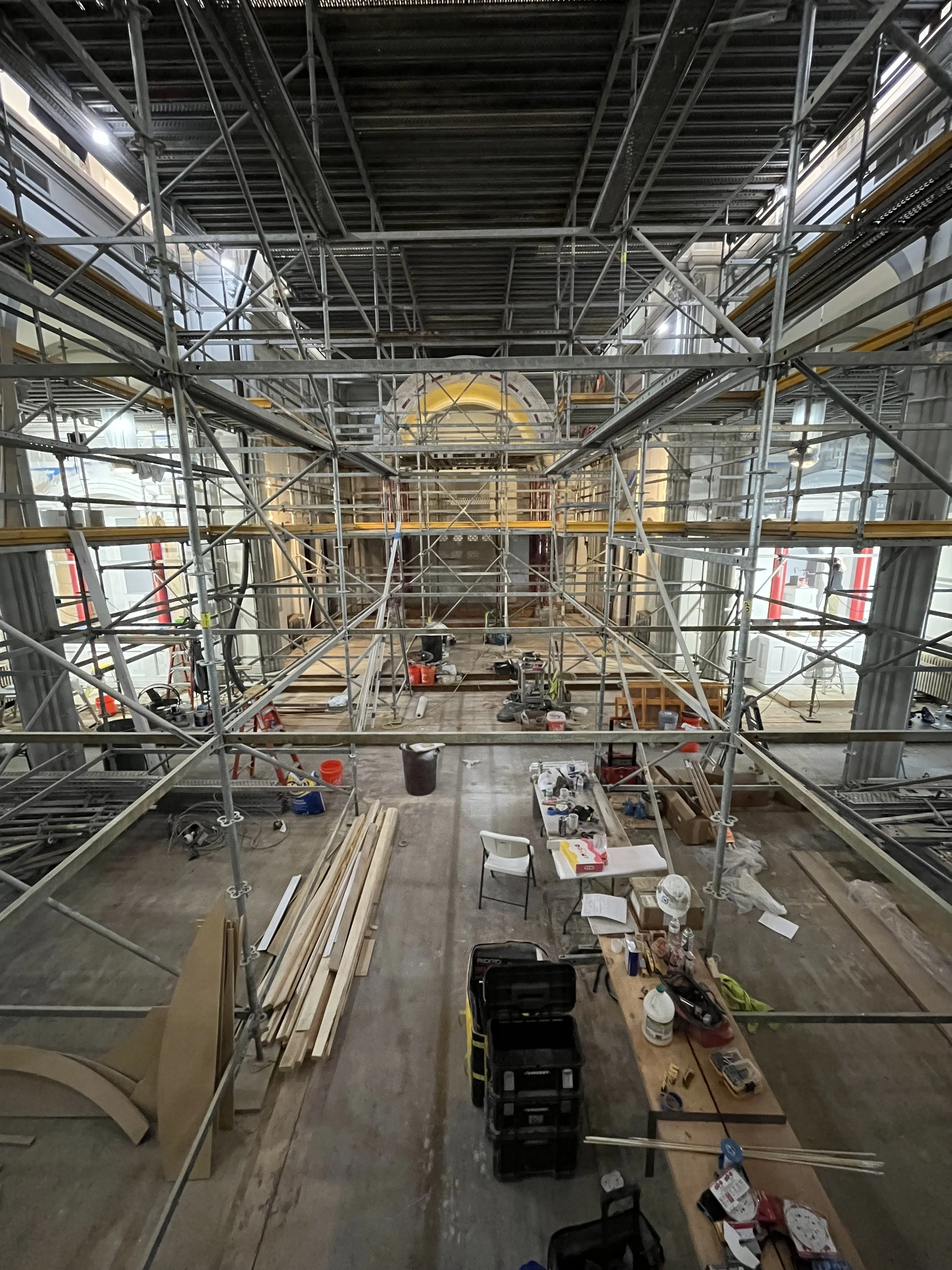 Construction scaffolding and tools inside a building.