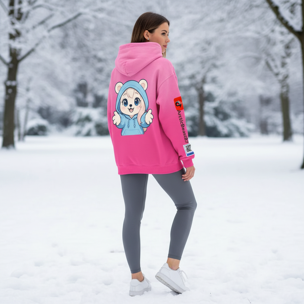 A woman standing outdoors in a snowy landscape wearing a bright pink hoodie with a cartoon bear character on the back and the TikTok logo with a QR code on the sleeve, paired with gray leggings and white sneakers.
