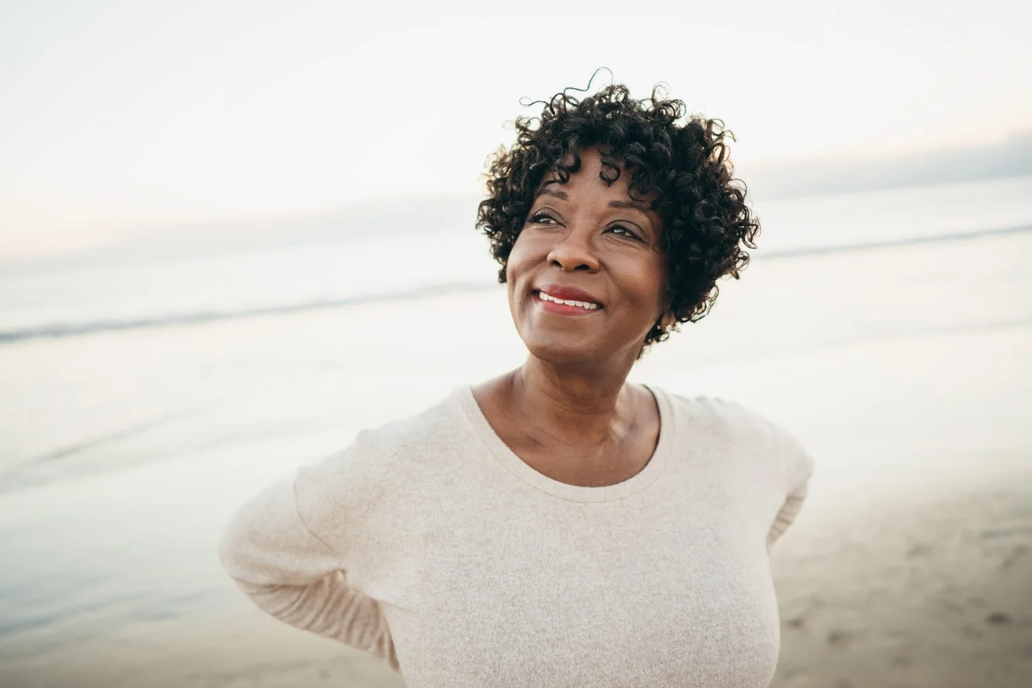 Smiling woman with short curly grey hair, embodying her next chapter