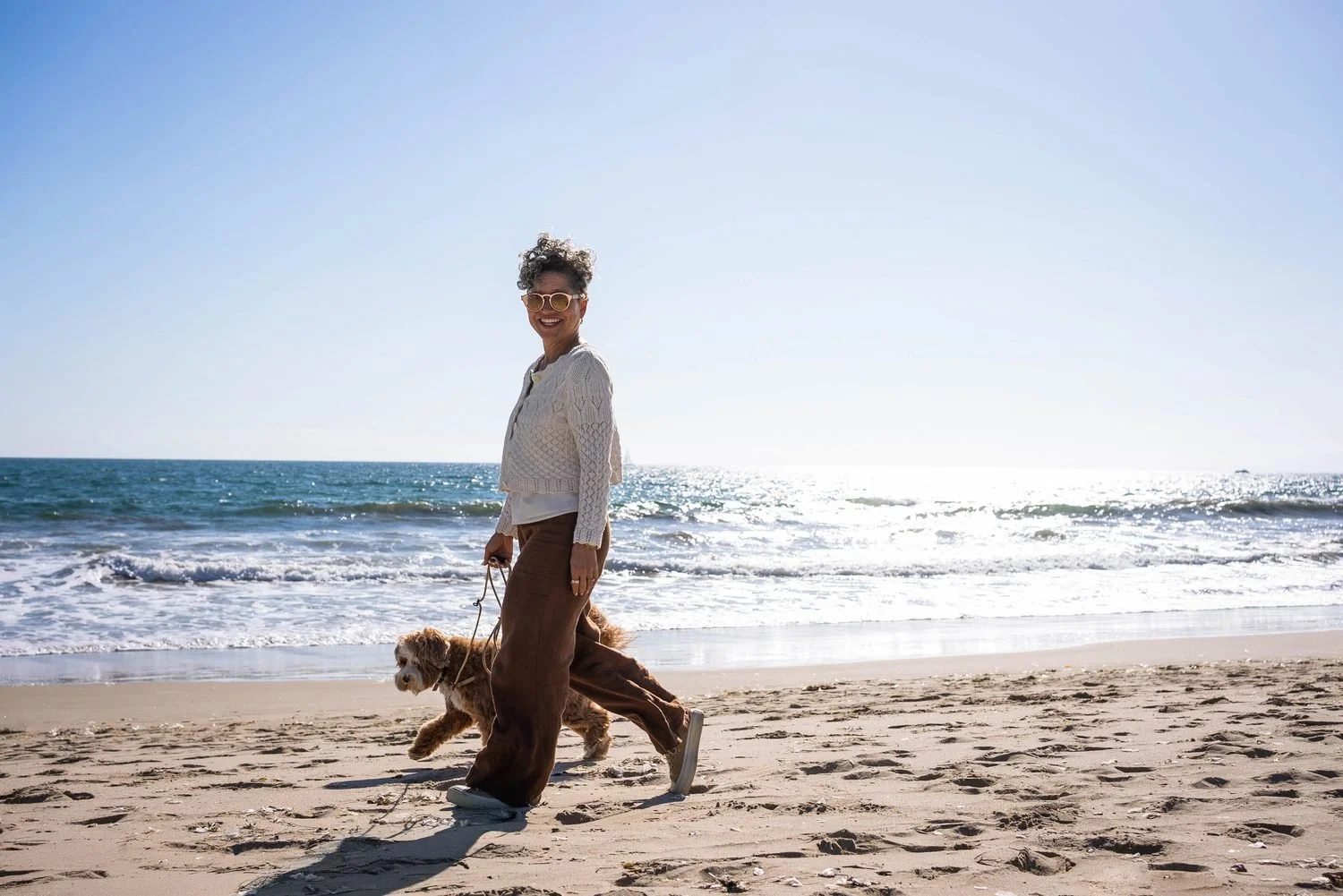 Kerry Ann Rockquemore walking along the beach with her dog