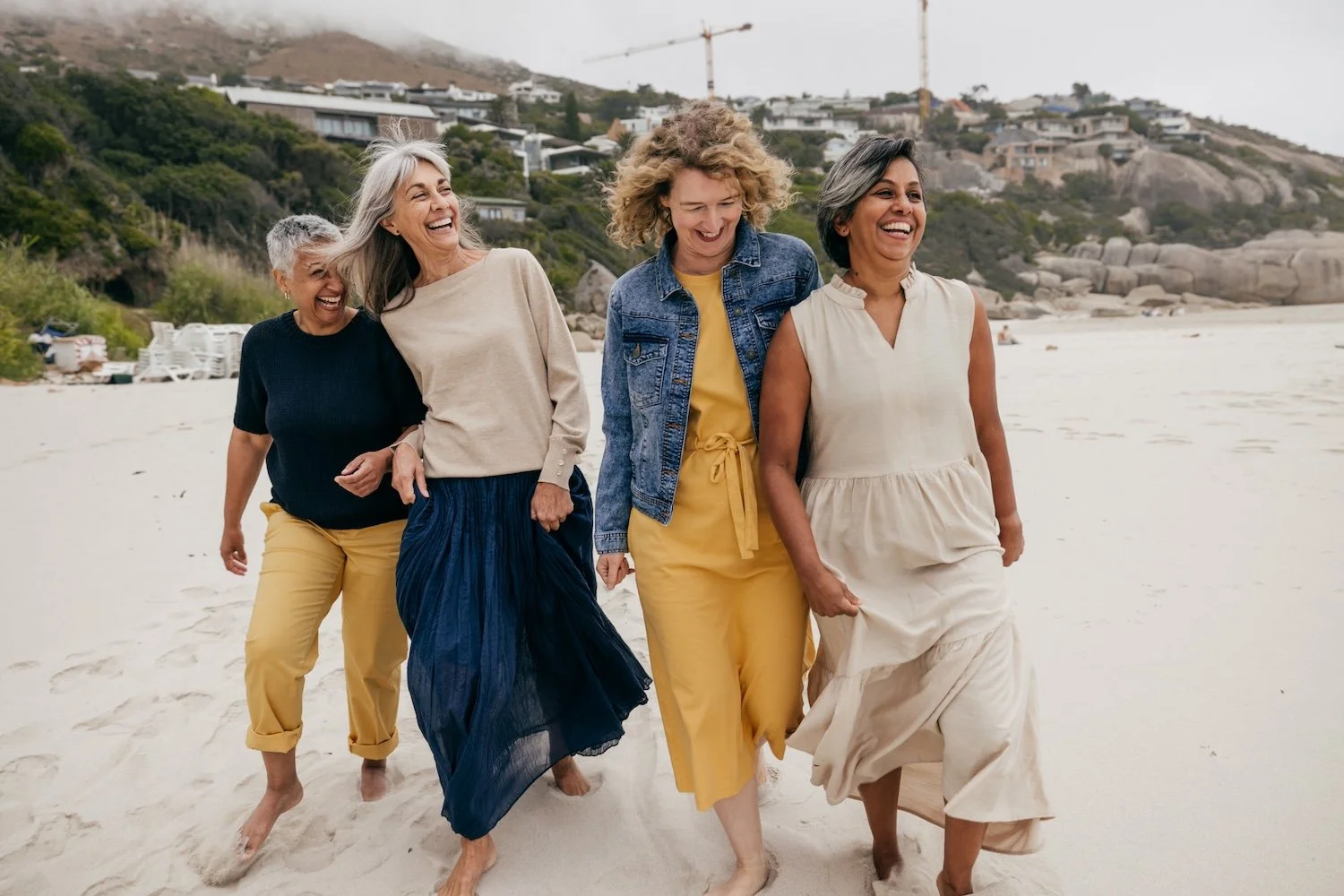 A group of women walking together outdoors, smiling and chatting