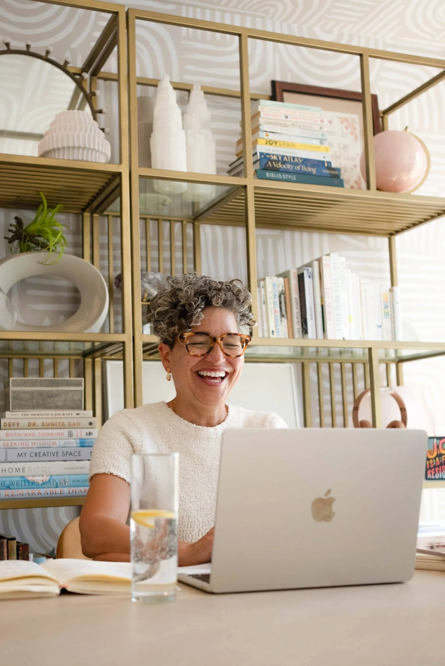 Kerry Ann Rockquemore working at her desk at home, surrounded by books