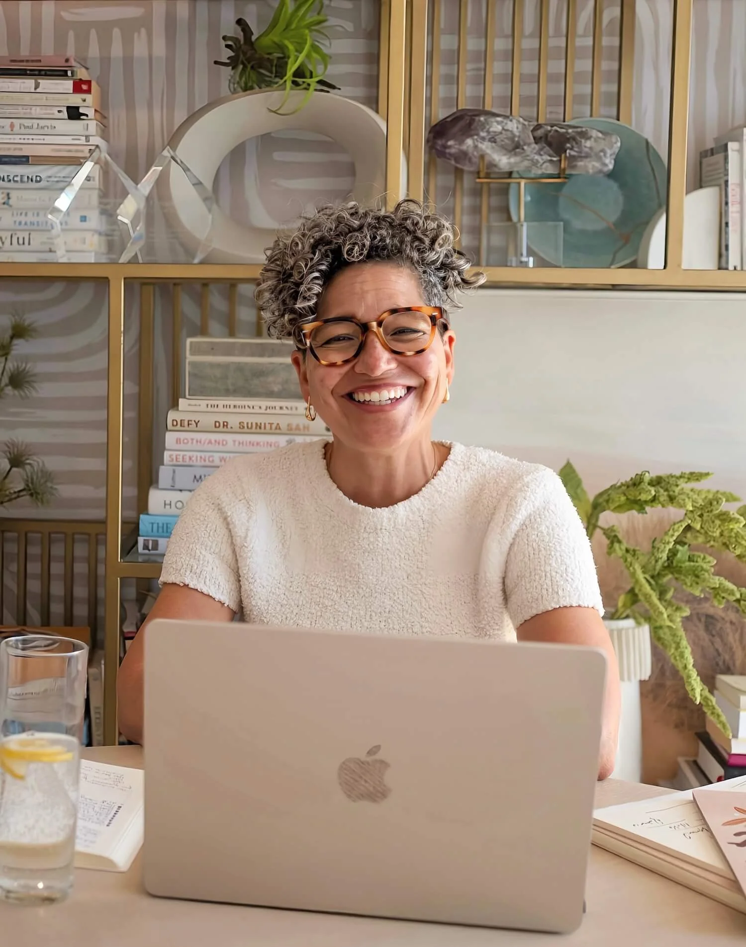 Kerry Ann Rockquemore working at her desk, surrounded by plants and books