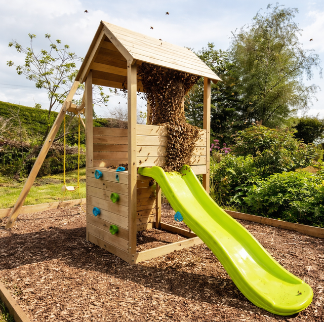 Children's playset with buzzing bee swarm near wooden posts