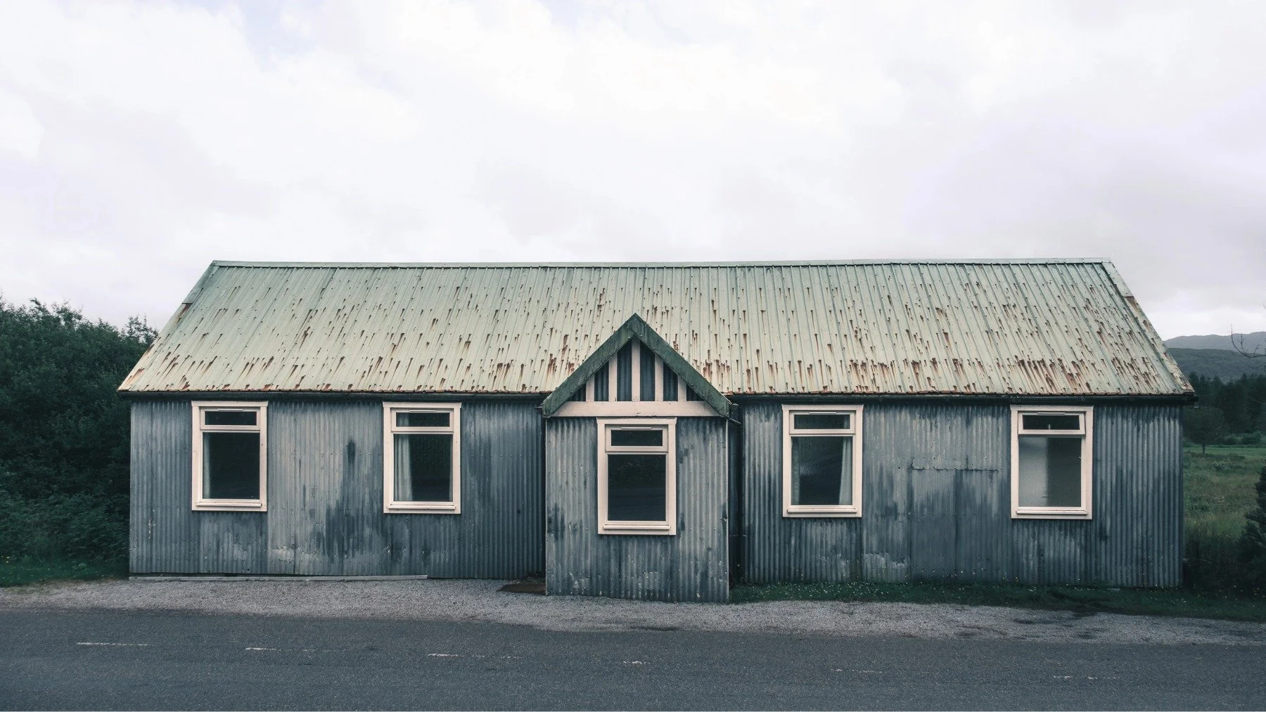 A blue wall, green roof painted corrugated tin/iron building used as a village hall | Mingarry Park Moidart Scotland | Steven Marshall Photography