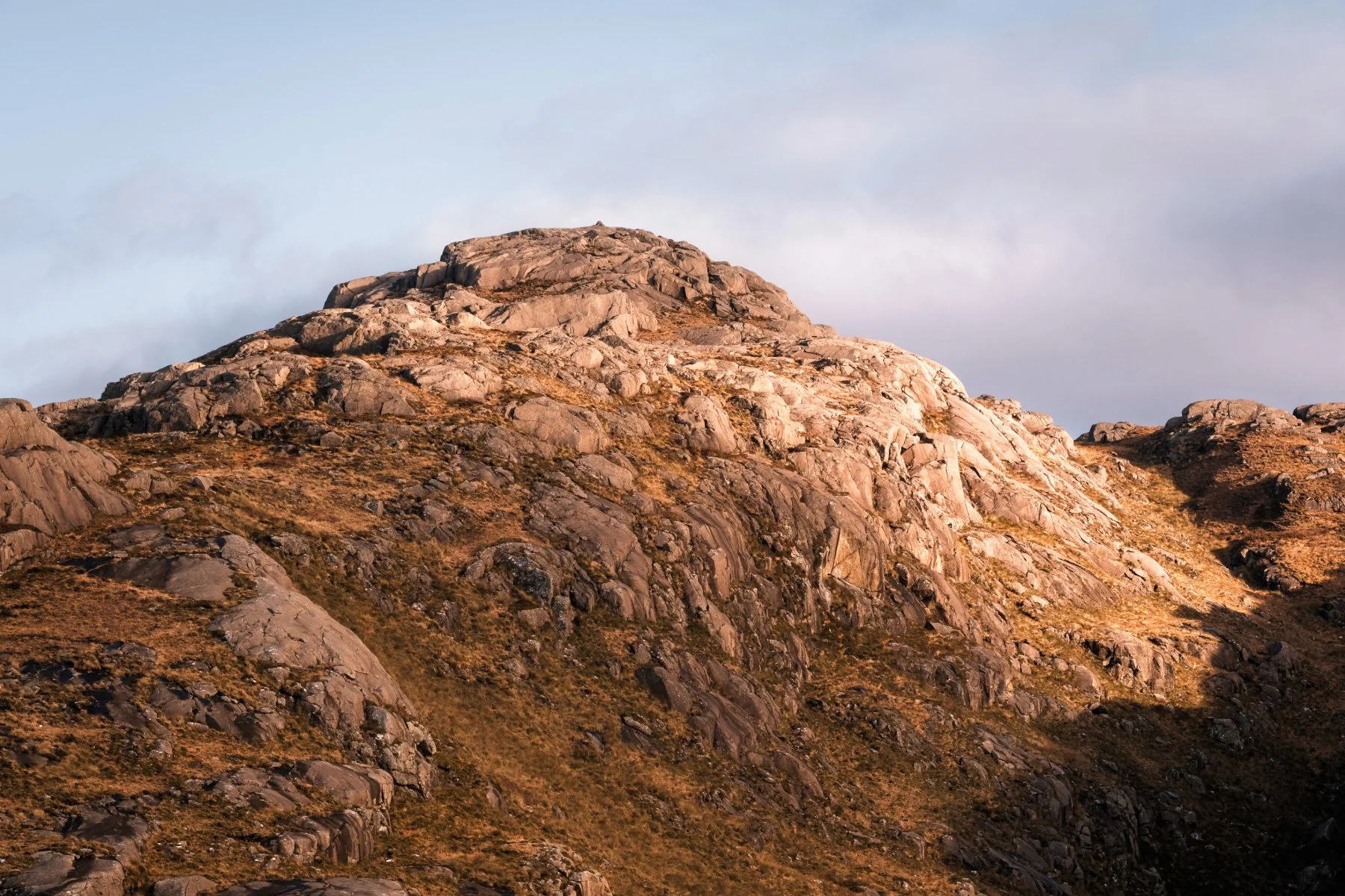The rocky summit of Meall Sanna illuminated by the late afternoon light | Ardnamurchan Scotland | Steven Marshall Photography