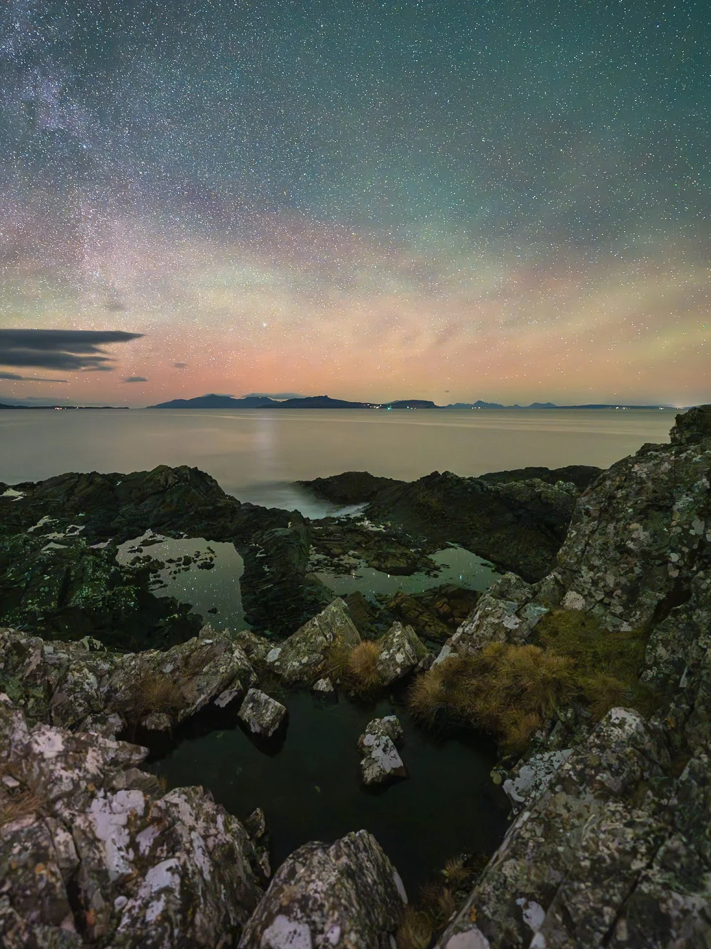 A night sky view across the sea to the Small Isles from Fascadale with airglow and stars in the sky | Ardnamurchan Scotland | Steven Marshall Photography