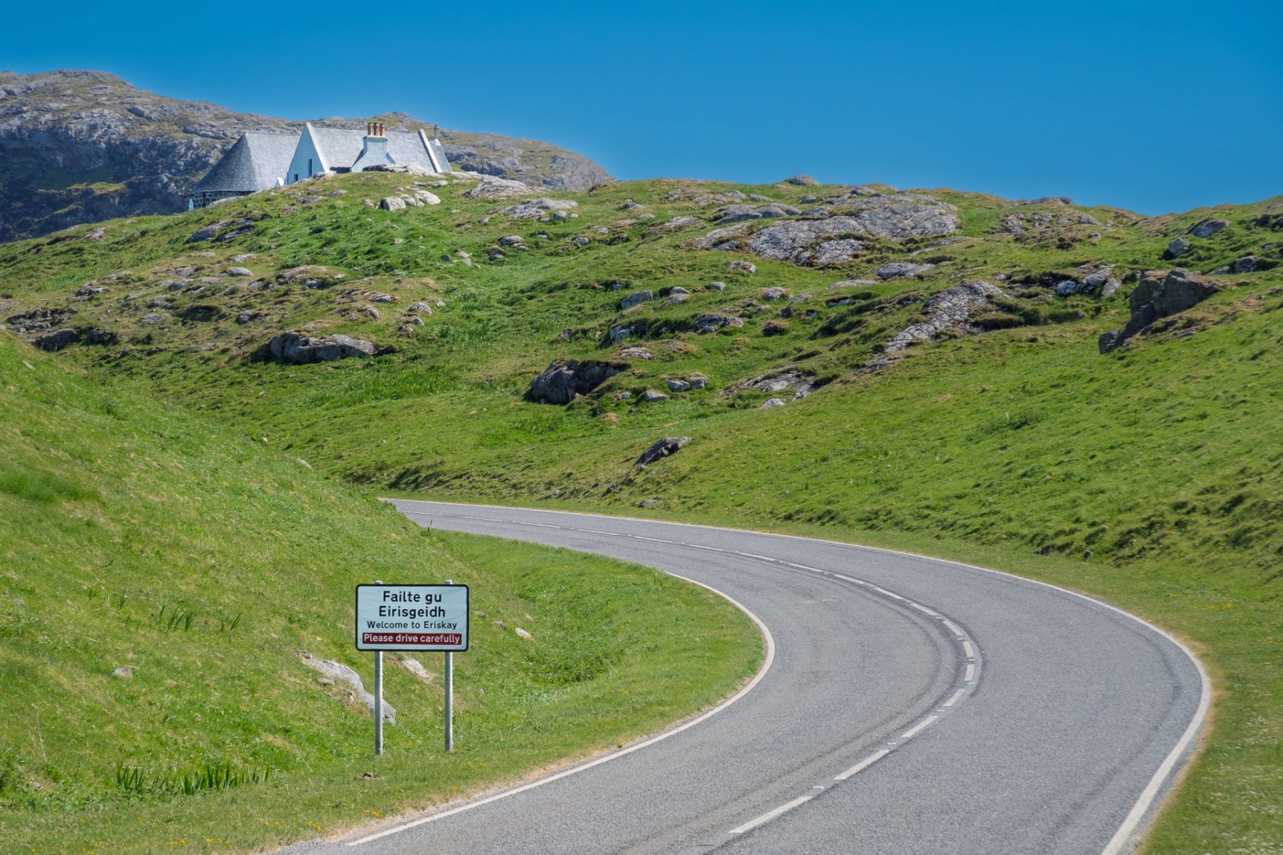 The road on Eriskay from the causeway with the welcome sign to the island | Outer Hebrides Scotland | Steven Marshall Photography