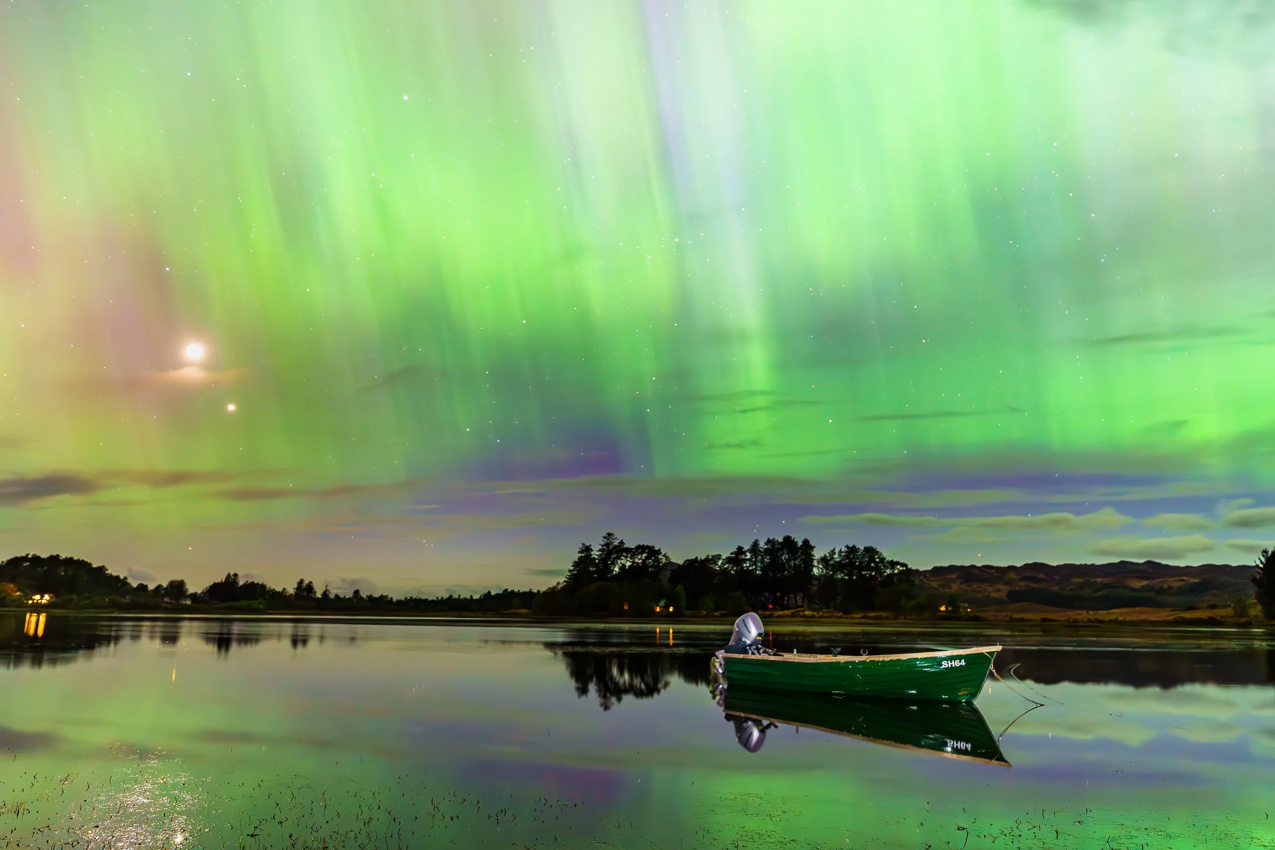 A green boat moored on Loch Shiel, sitting under pillars of aurora from Northern Lights, Acharacle | Ardnamurchan, Scotland | Steven Marshall Photography