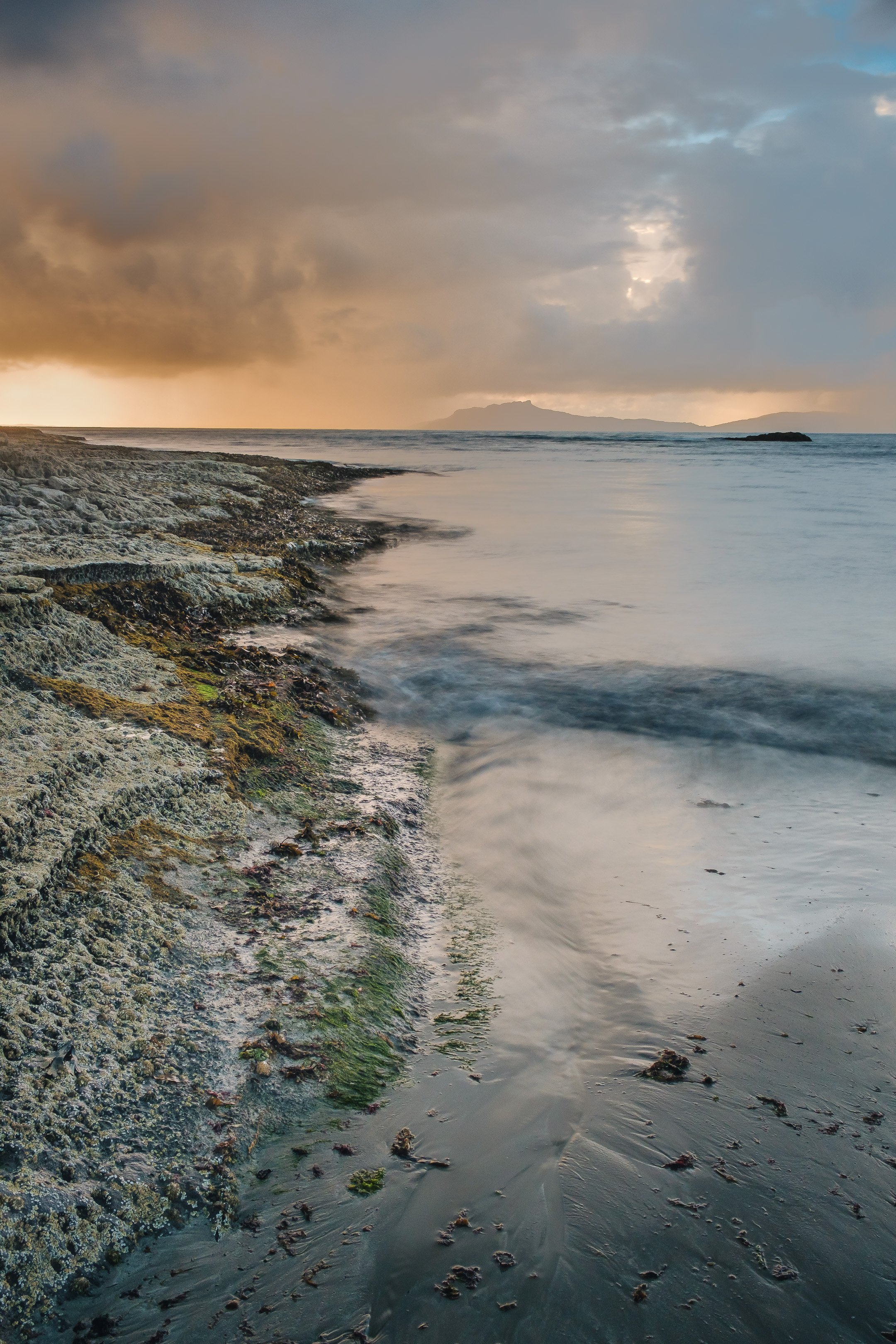 Storm clouds roll in to the north of Swordle Bay to conceal the Isle of Eigg | Ardnamurchan Scotland | Steven Marshall Photography