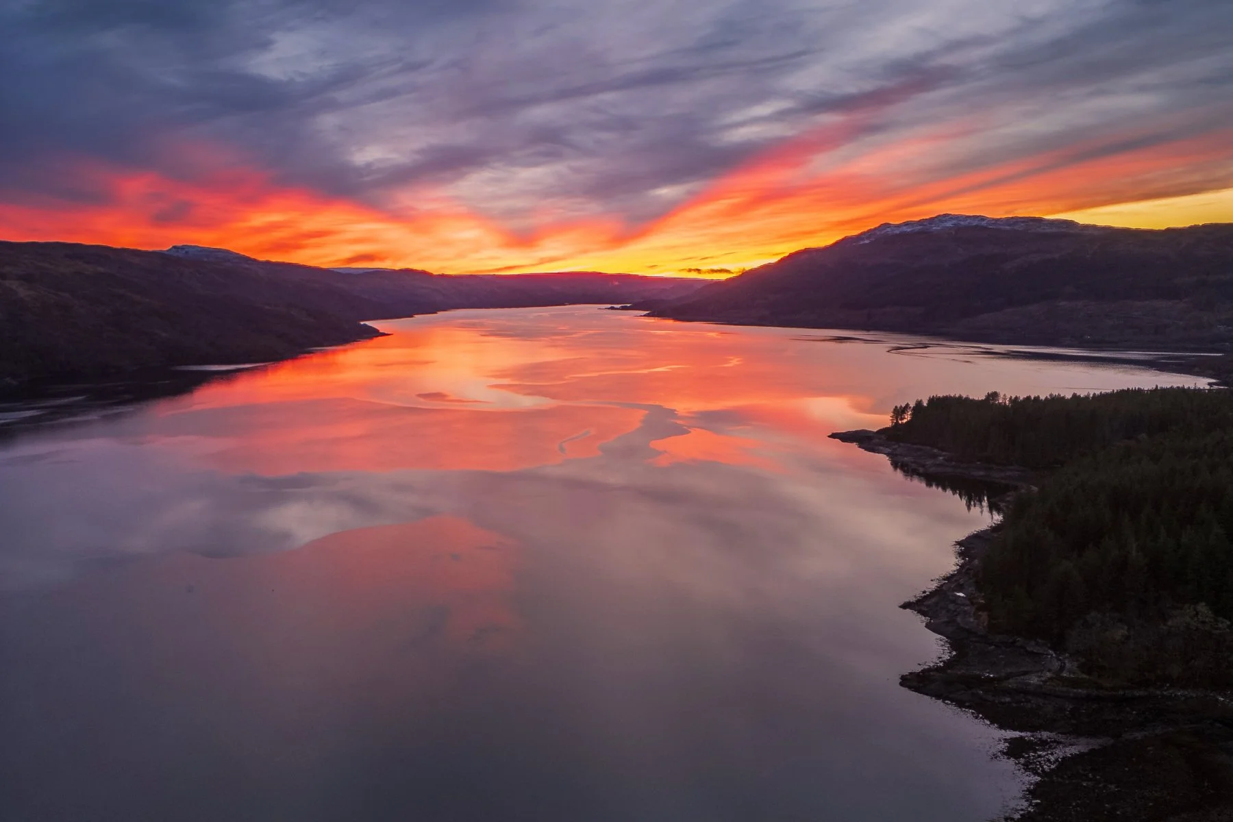 A red sky at sunset reflected in the calm surface of Loch Sunart at Resipole | Sunart Scotland | Steven Marshall Photography