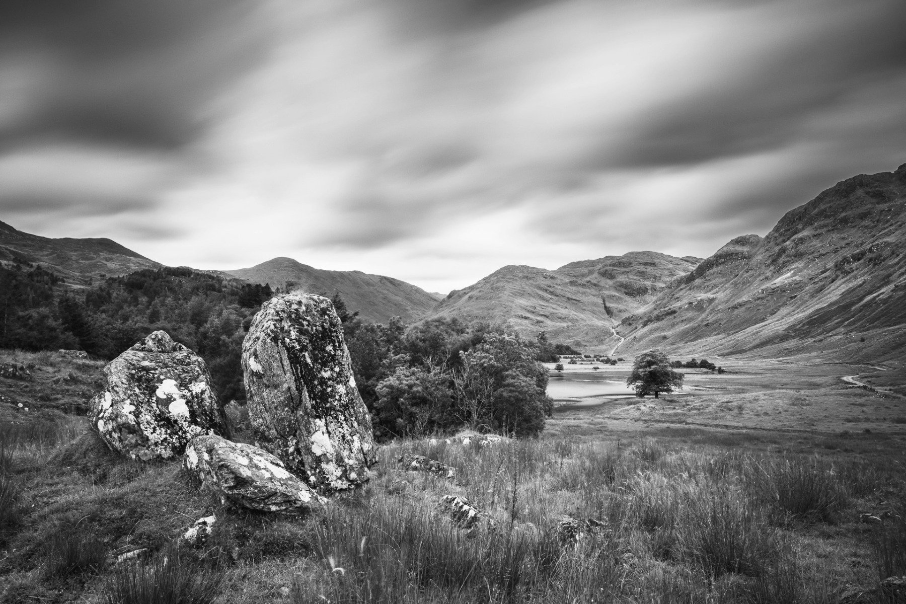 Long exposure black and white image of boulders standing on the hillside at the entrance to a highland glen | Glen Moidart Scotland | Steven Marshall Photography