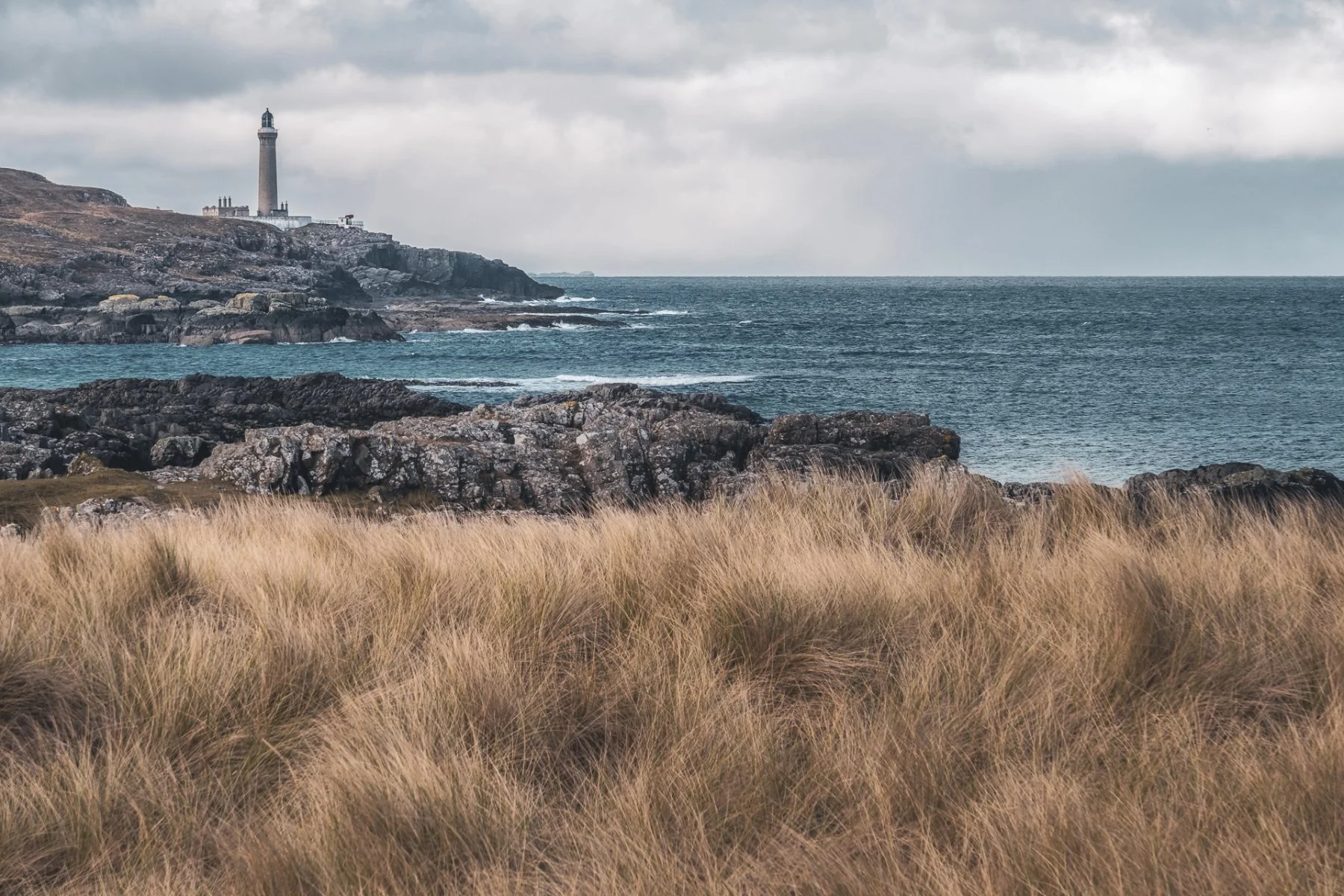Ardnamurchan Lighthouse viewed across the marram grass and sea from Port na Carraidh (Bay MacNeil) | Ardnamurchan Scotland | Steven Marshall Photography