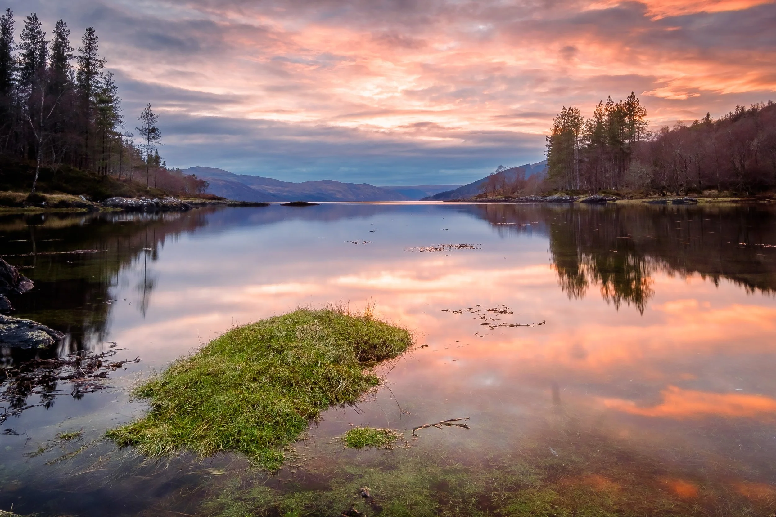 The calm waters of the Sàilean nan Cuileag at sunset mirroring the clouds and sky | Ardnamurchan Scotland | Steven Marshall Photography