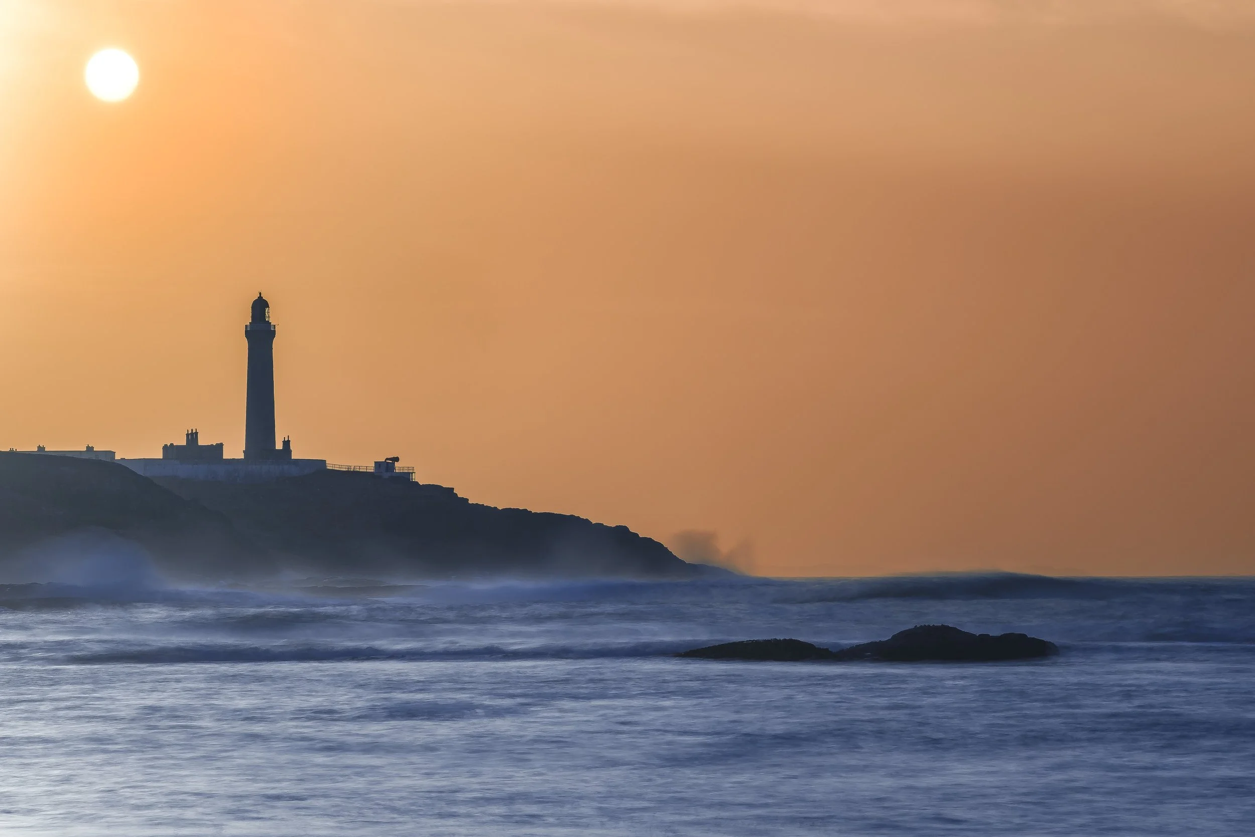 Ardnamurchan Lighthouse against the backdrop of an orange sky | Ardnamurchan Scotland | Steven Marshall Photography