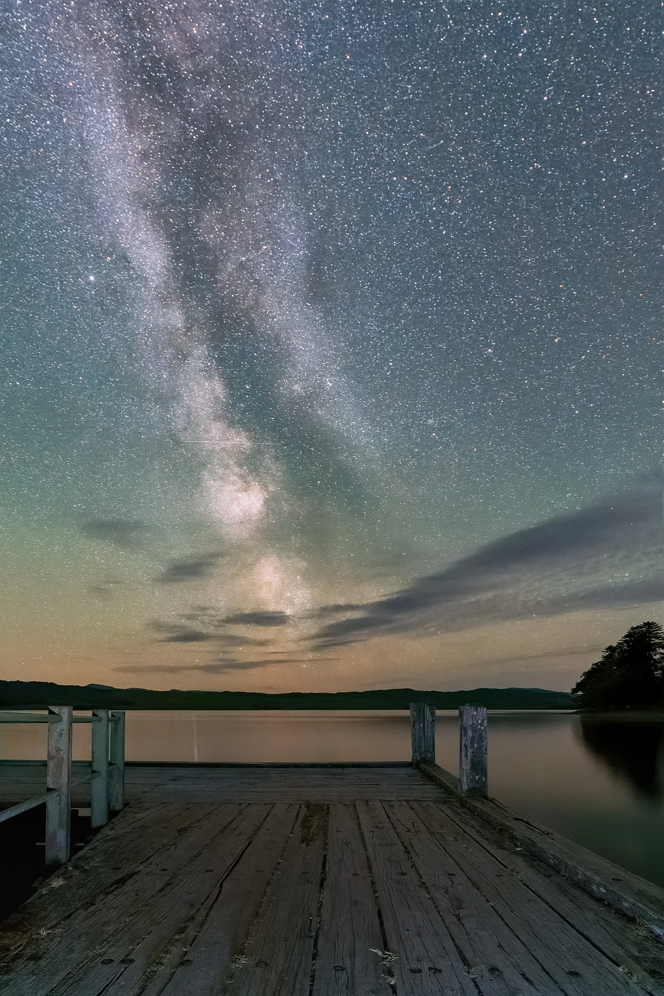 The Milky Way in a star filled night sky above a wooden jetty in Loch Shiel | Moidart Scotland | Steven Marshall Photography