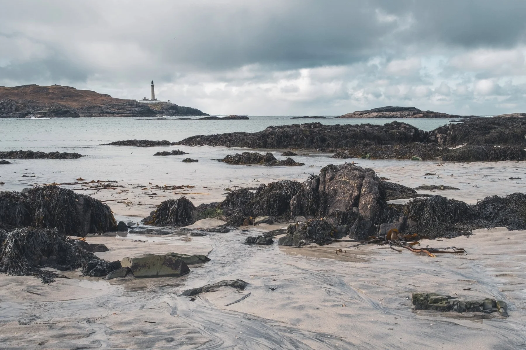 Ardnamurchan Lighthouse and rocks viewed from the beach at Port na Carraidh (Bay MacNeil) | Ardnamurchan Scotland | Steven Marshall Photography