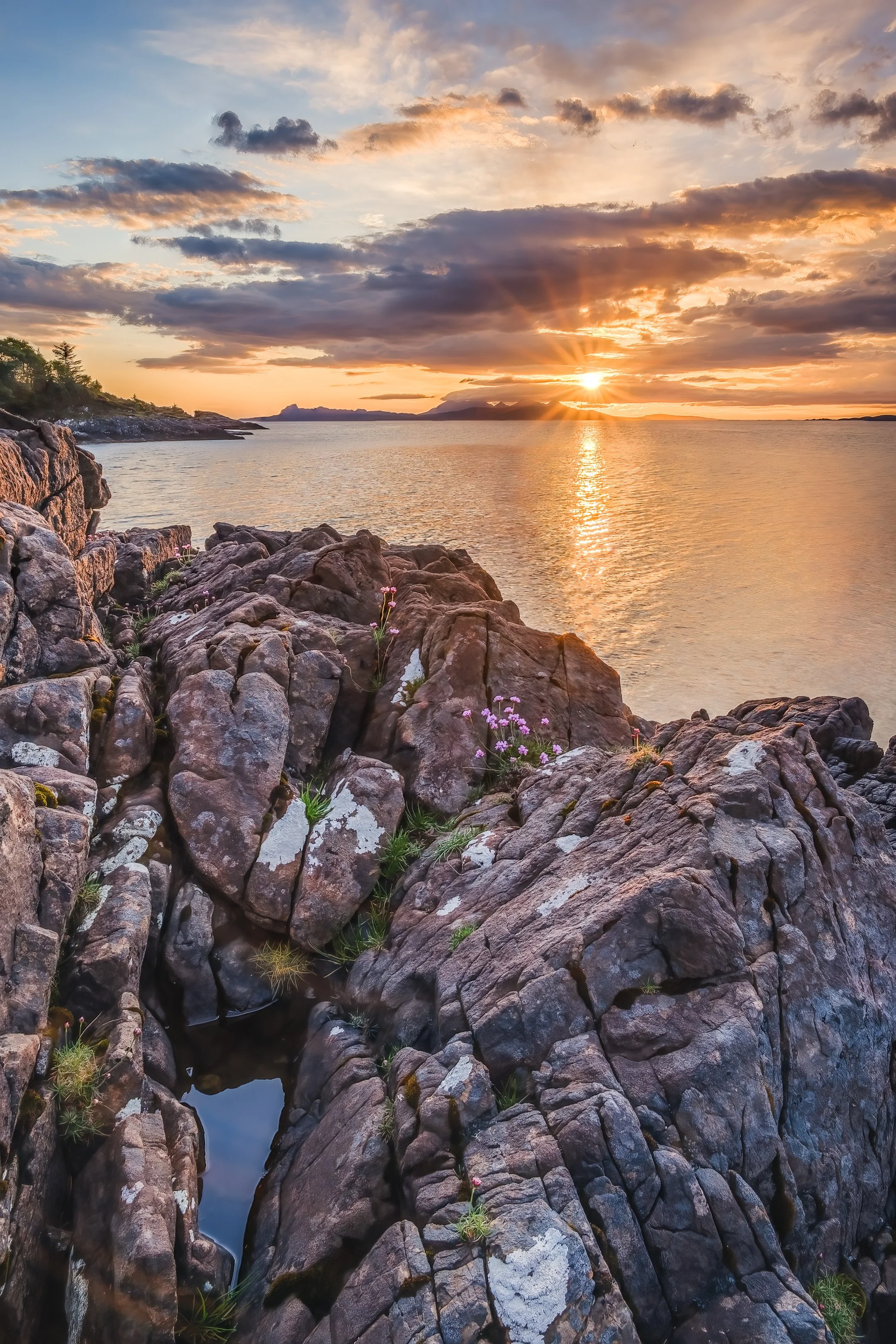 A sunburst above the Small Isles viewed from Samalaman, Glenuig | Moidart Scotland | Steven Marshall Photography
