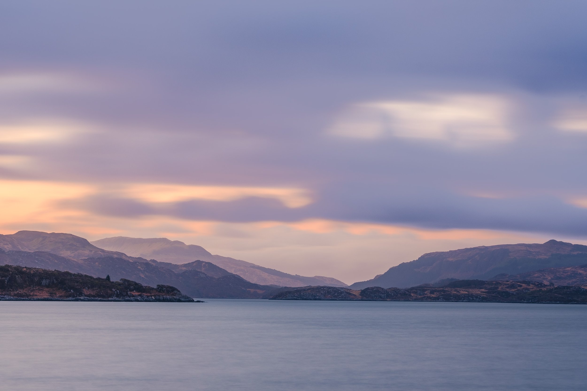 Scenic view of Loch Sunart with mountains in the distance under a cloudy sky at dusk | Steven Marshall Photography