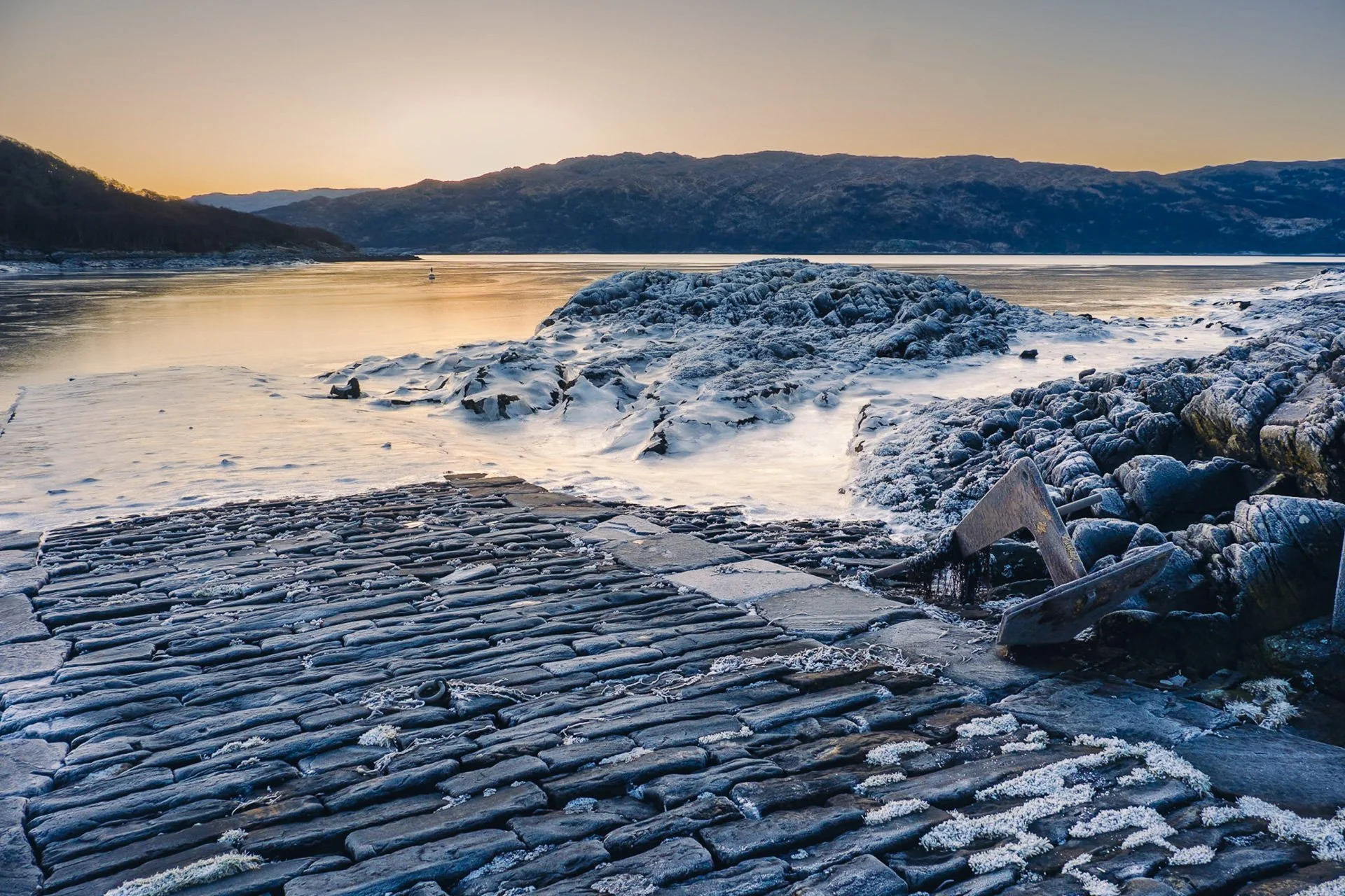 The stone jetty in Salen Bay with ice on rocks and a frozen Loch Sunart | Ardnamurchan Scotland | Steven Marshall Photography