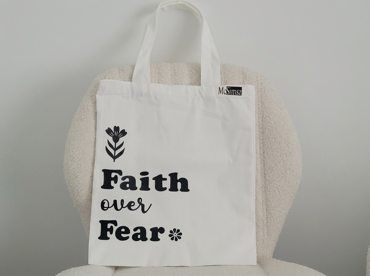 Faith Over Fear inspirational tote bag in white with black floral design and bold typography