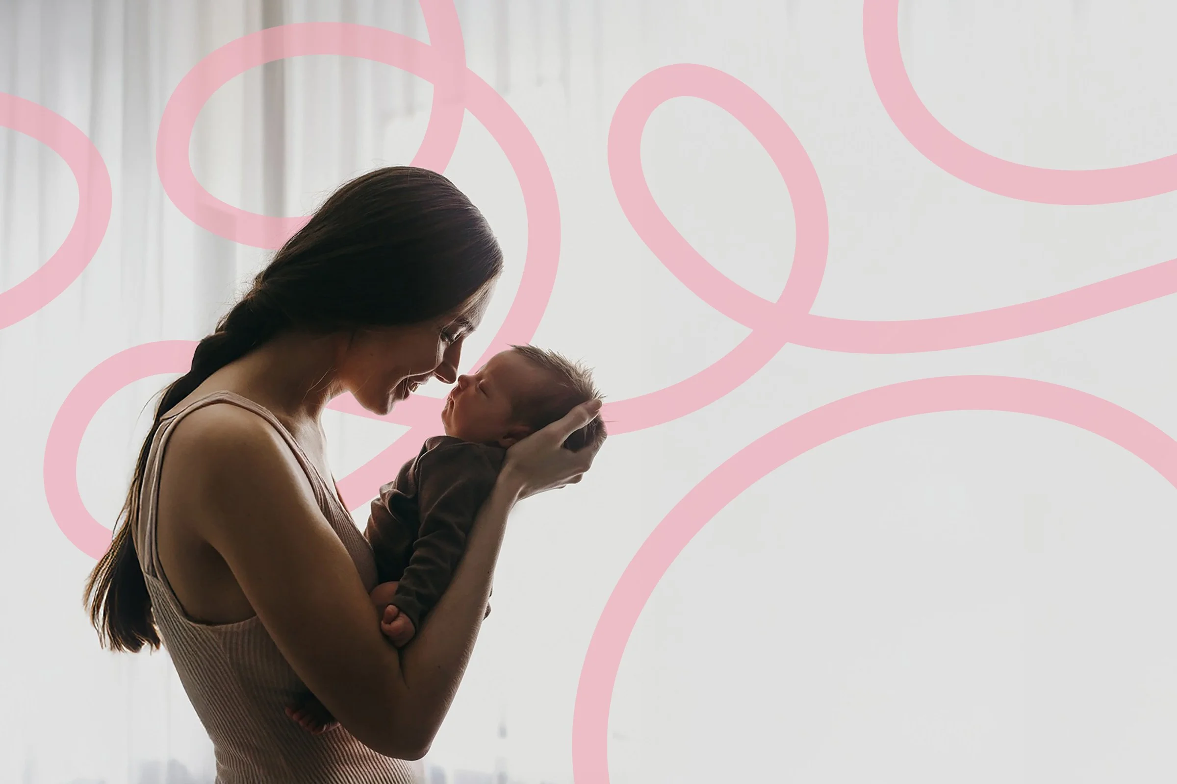 A woman holding a baby and looking at each other with smiles in a softly lit room with white curtains. Pink swirly graphic overlay in the background.