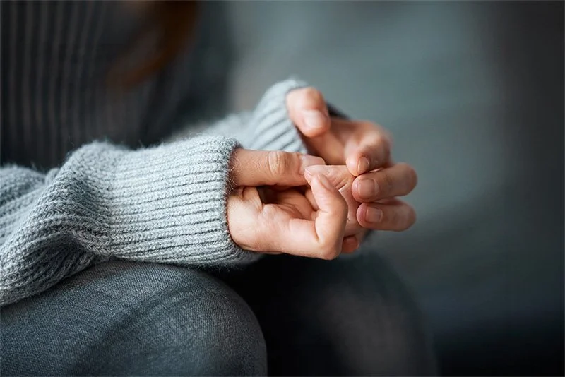 Close-up of a woman nervous hands, representing birth trauma support and therapy for difficult birth processing