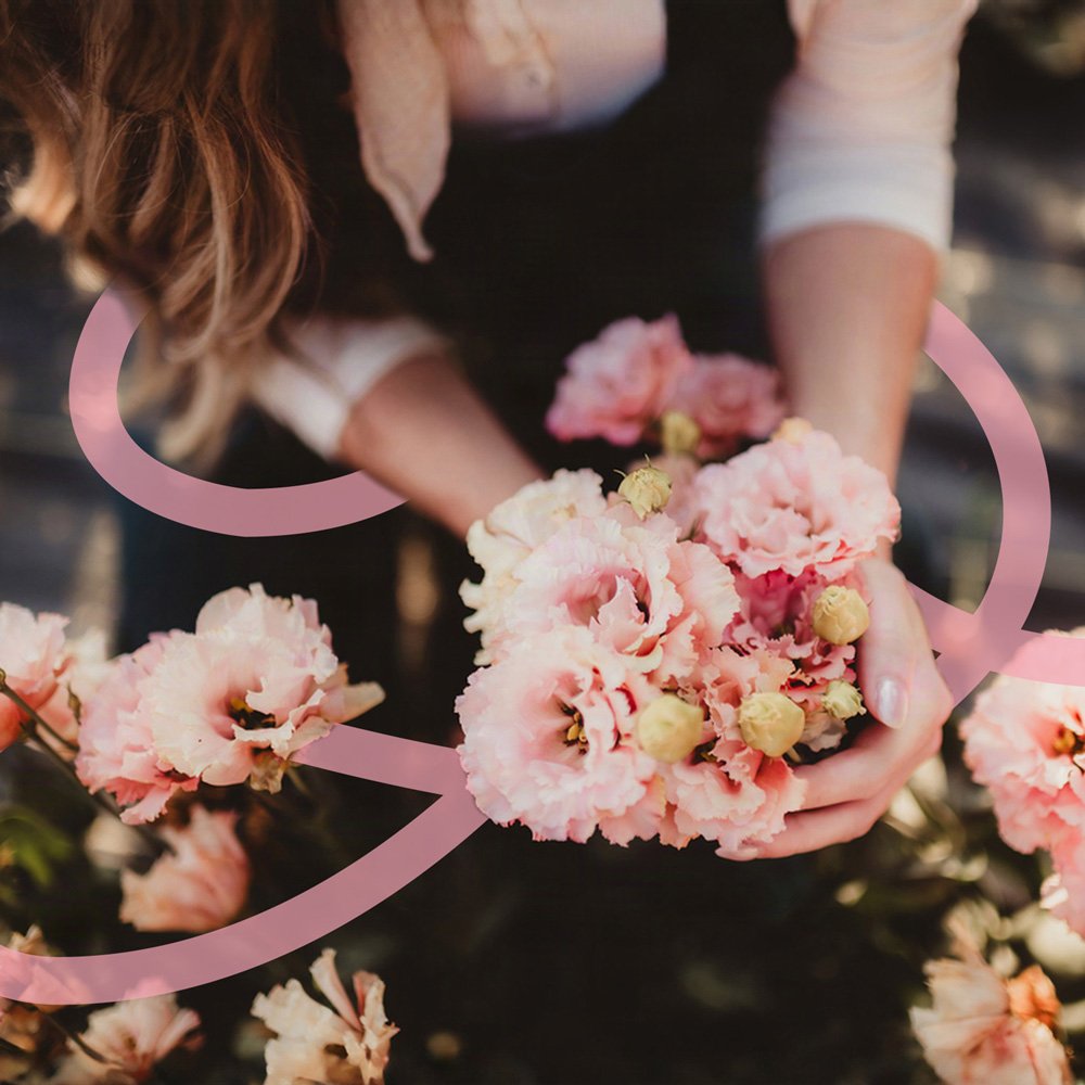 Close-up of a woman holding a soft floral bouquet, illustrating gentle mental health support across fertility and motherhood