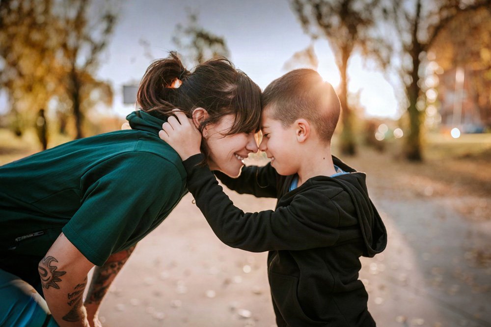 Mother sharing a loving moment outdoors with her young child, illustrating early motherhood psychology support