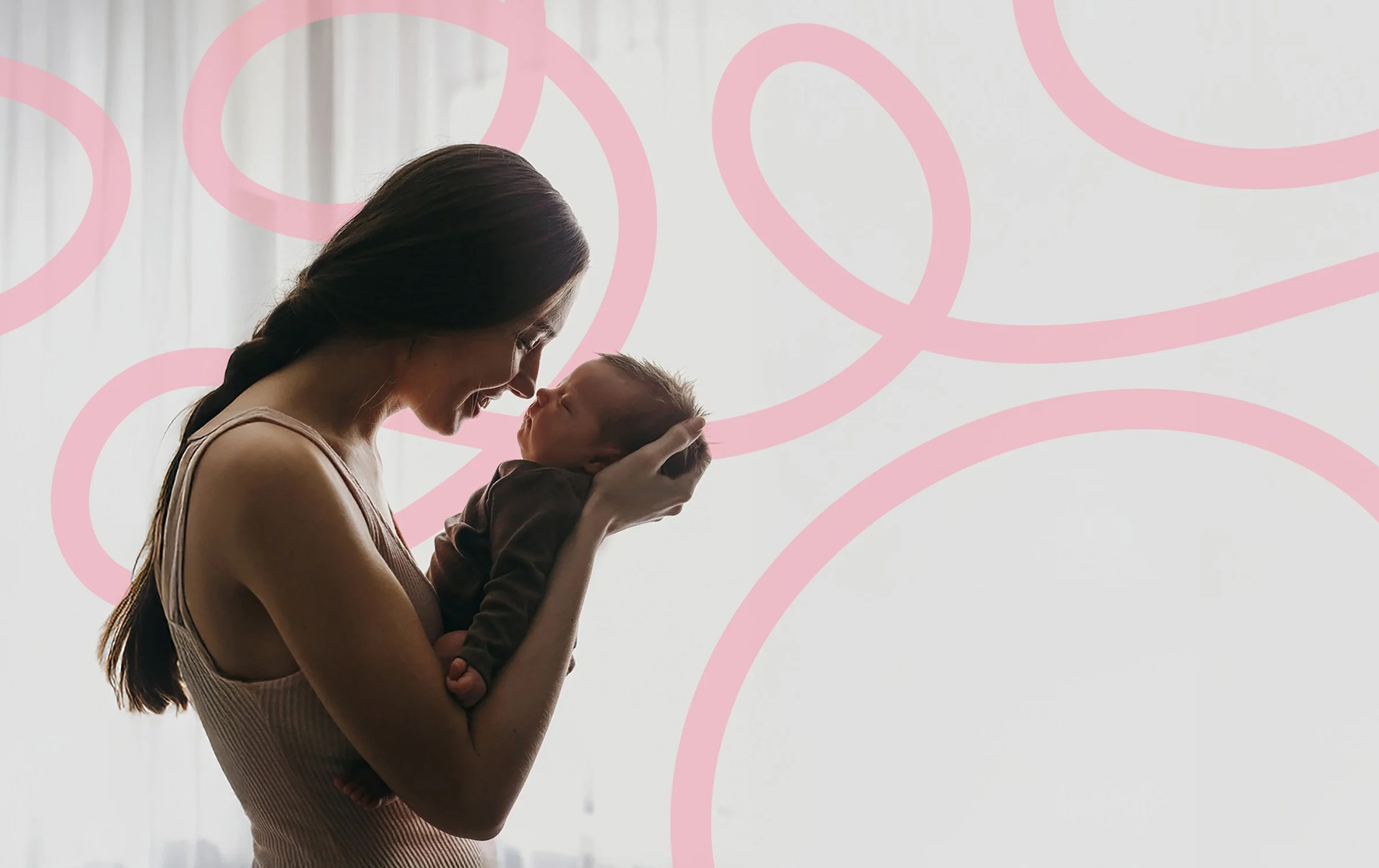 A woman holding a newborn baby close to her face, both with eyes closed and smiling, set against a background with pink swirling lines.