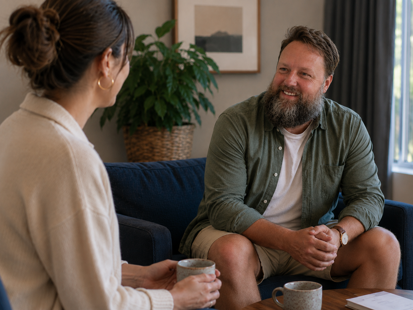 James from Gold Coast Assisted Service sitting and talking with another person in a relaxed setting.