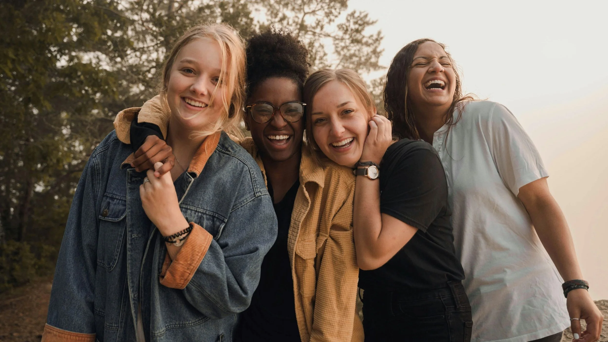 Women smiling in the sun at a Kyria Network leadership event.