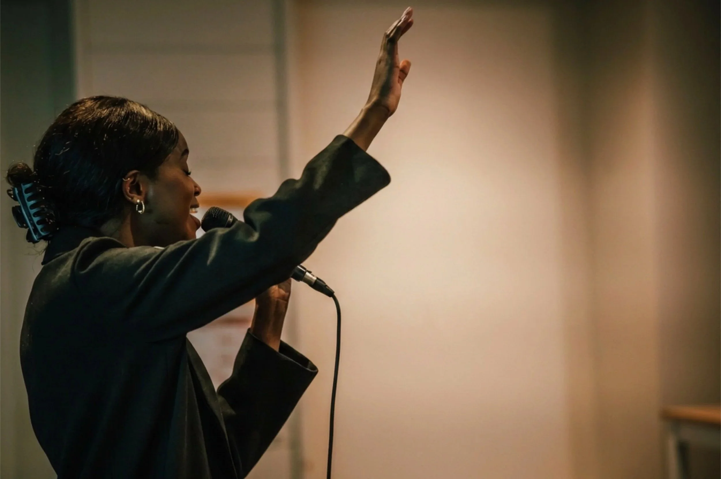 A woman praising God from stage.