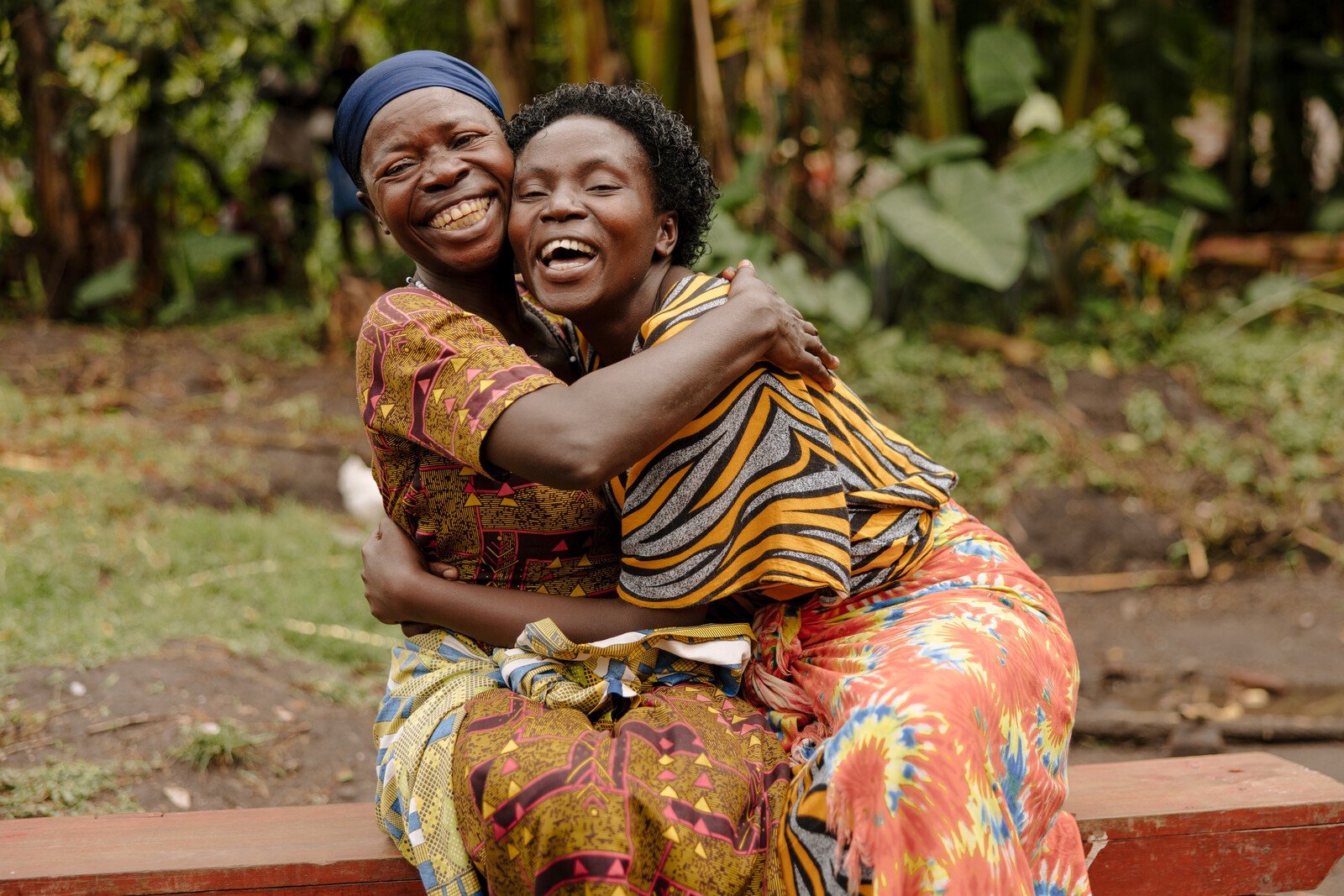 Women in Africa smiling and laughing together.