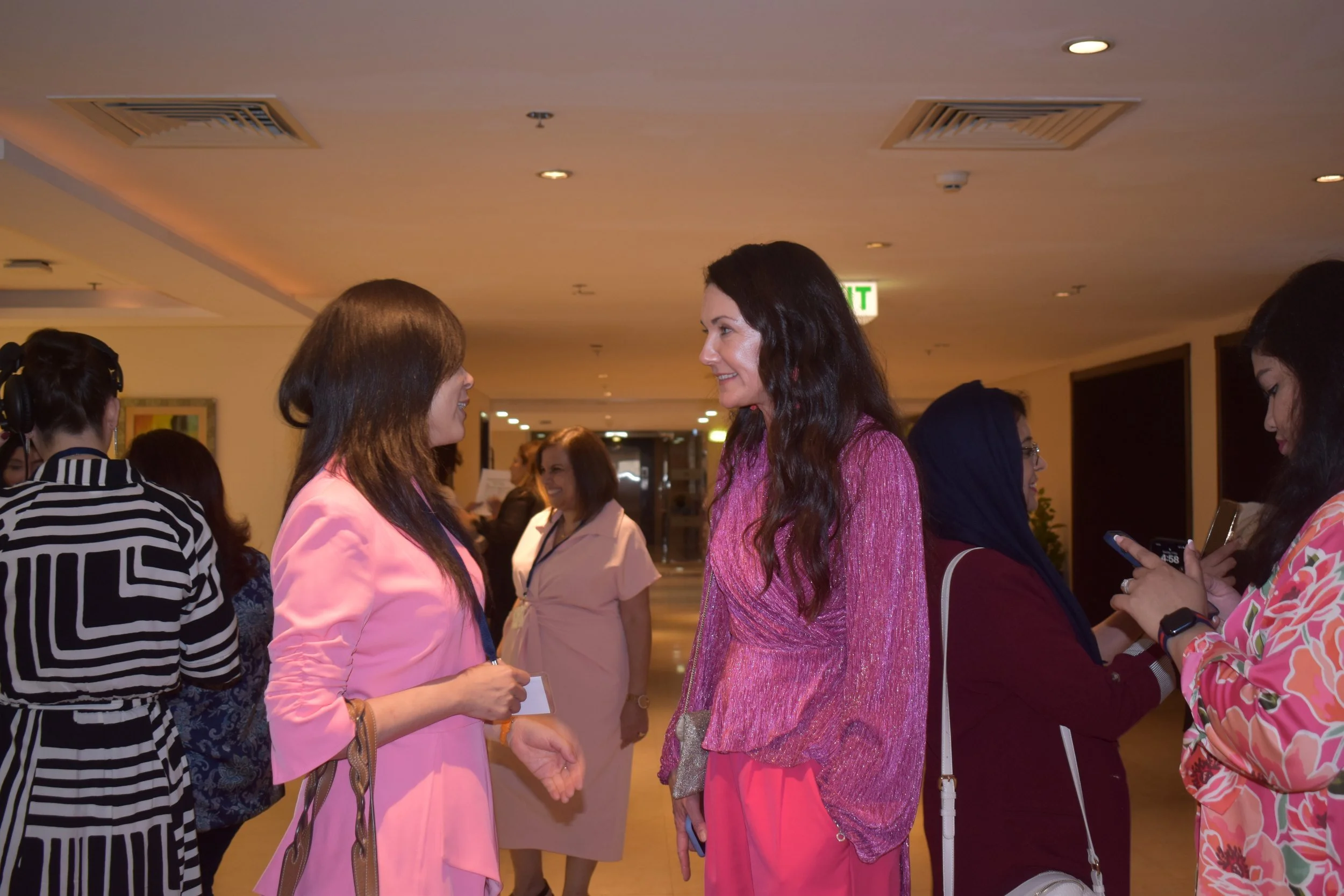 Two women talking at a leadership development event.